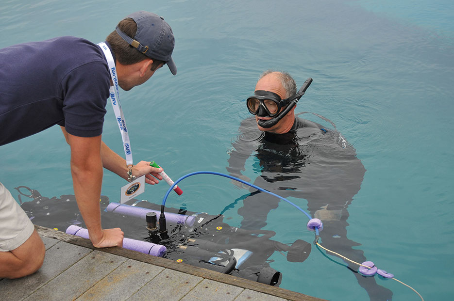 Space and Naval Warfare Systems Center Pacific diver assists University of Florida team member with in-water checks to university’s “Subjugator” Autonomous Underwater Vehicle during 14th Annual International RoboSub Competition, July 13, 2011 (U.S. Navy/Rick Naystatt)
