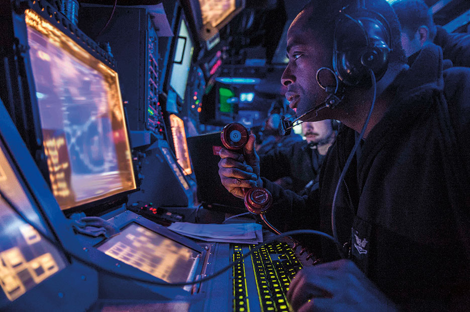Sailor assigned to USS Mustin stands watch in ship’s combat information center during Exercise Valiant Shield 2014, which integrates about 18,000 U.S. Navy, Air Force, Army, and Marine Corps personnel, more than 200 aircraft, and 19 surface ships for real-world joint operational experience, September 16, 2014 (U.S. Navy/Declan Barnes)