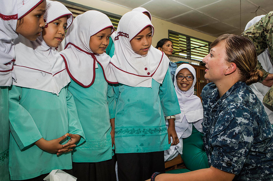 U.S. Navy Hospital Corpsman talks with students from Andalas Primary School during subject matter expert exchange held at Andalas Social Health Clinic, during Pacific Partnership 2016, August 26, 2016 (Royal Australian Air Force/David Cotton)