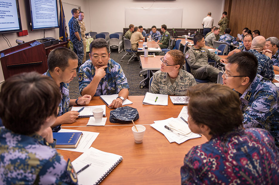 People’s Liberation Army Navy hospital ship Peace Ark Senior Captain Sun Tao shares medical experiences during group activity during Fundamentals of Global Health Engagement Course at Makalapa Clinic as part of Rim of the Pacific 2016, Joint Base Pearl Harbor–Hickam, July 11, 2016 (U.S. Navy/Katarzyna Kobiljak)