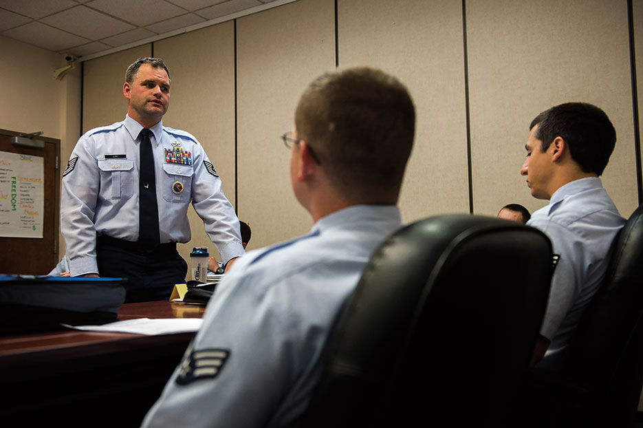 Professional military education instructor, 62nd Airlift Wing, speaks with students about results of their graded assignment, August 26, 2015, at Julius A. Kolb Airman Leadership School at Joint Base Lewis-McChord, Washington (U.S. Air Force/Sean Tobin)