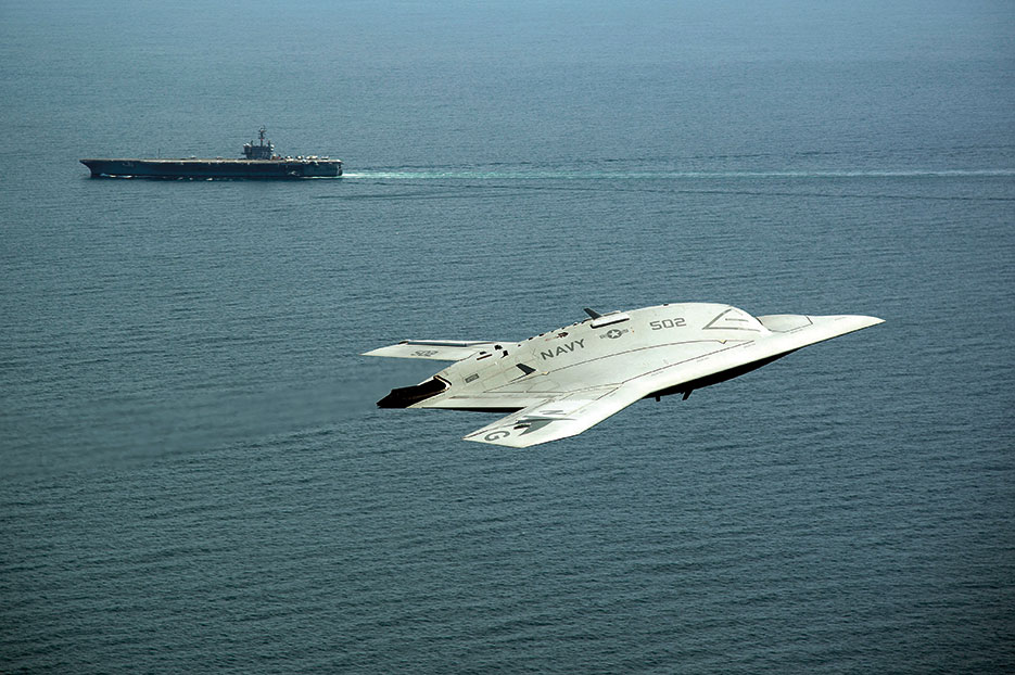 Unmanned Combat Air System X-47B demonstrator flies near aircraft carrier USS George H.W. Bush, first aircraft carrier to successfully catapult launch unmanned aircraft from its flight deck, May 14, 2013 (U.S. Navy/Erik Hildebrandt)