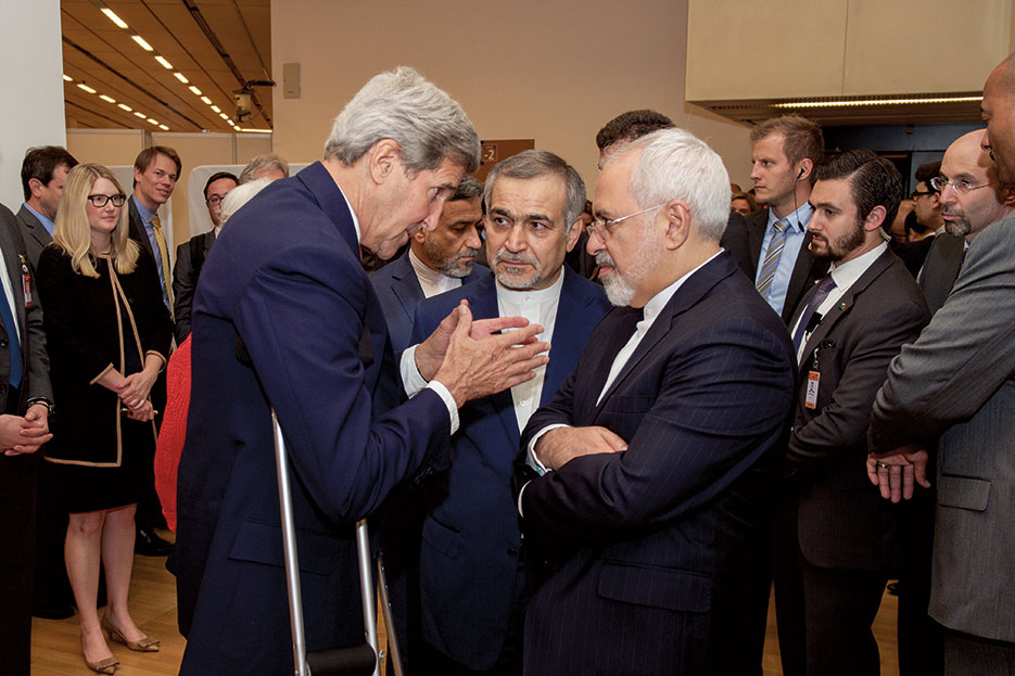 Secretary of State John Kerry speaks with Hossein Fereydoun, brother of Iranian President Hassan Rouhani, and Iranian Foreign Minister Javad Zarif before announcing historic nuclear agreement to reporters in Vienna, Austria (State Department)