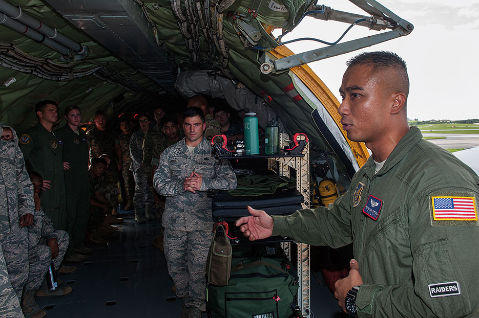 Airman from 18th Aeromedical Evacuation Squadron explains his role in aeromedical mission to students attending JPME Okinawa Experience, Kadena Air Base, Japan, September 2016 (U.S. Air Force/Corey M. Pettis)