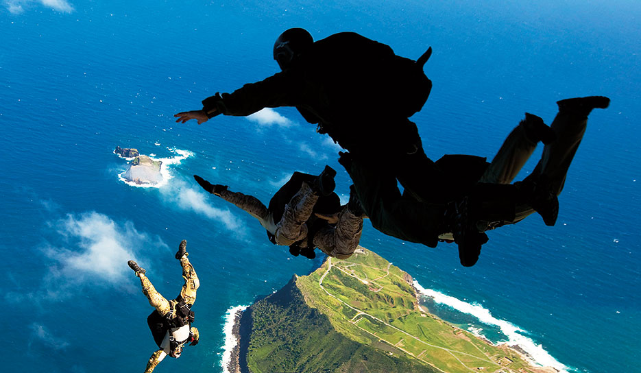 Air Force pararescuemen and West Coast–based Navy SEALs leap from ramp of Air Force C-17 transport aircraft during free-fall parachute training over Marine Corps Base Hawaii, January 2011 (U.S. Marine Corps/Reece E. Lodder)