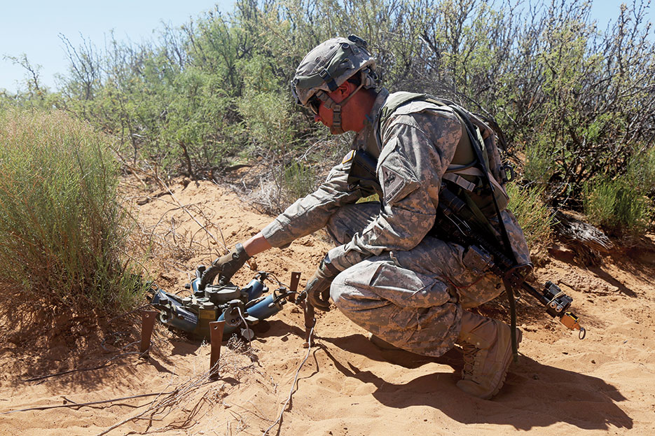 Soldier adjusts M7 Spider Networked Munitions during Network Integration Evaluation 16.2 at training village Kamal Jabul, Fort Bliss, Texas, May 2016 (U.S. Army/Chenee’ Brooks)