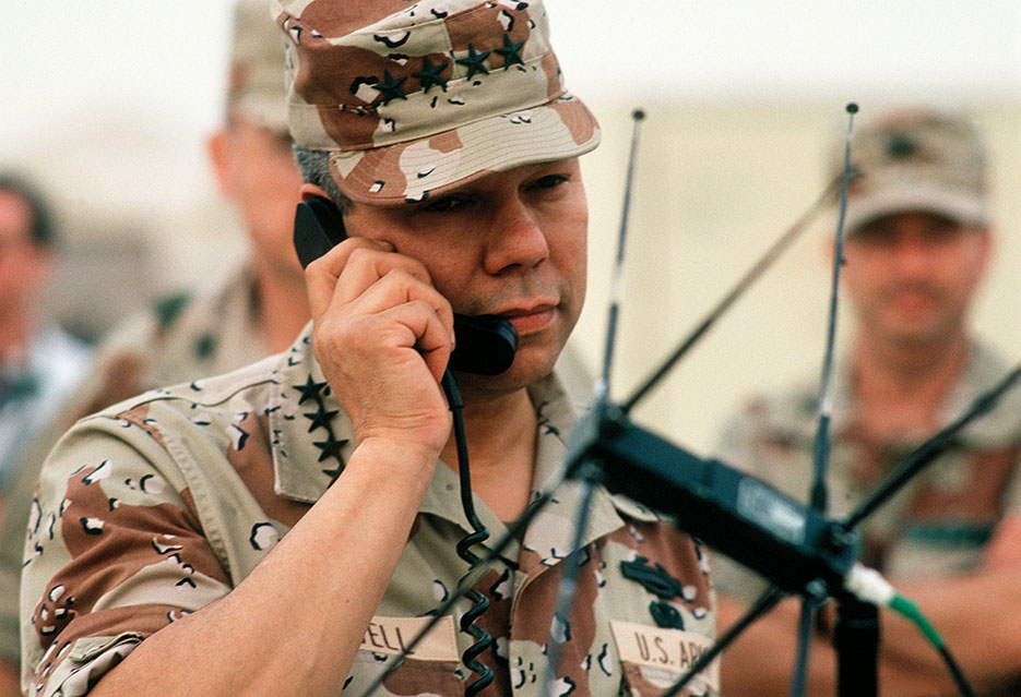 Chairman of the Joint Chiefs of Staff General Colin Powell speaks via satellite to Pentagon while visiting troops during Operation Desert Shield (DOD/Jeff Wright)