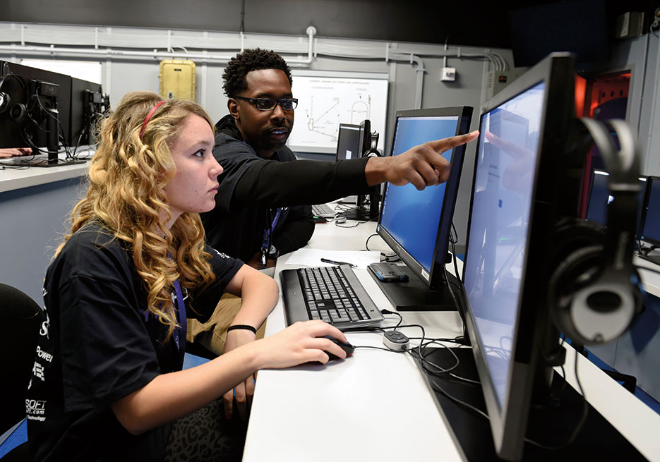 Joint Cyber Analysis Course instructor at Information Warfare Training Command Corry Station helps high school student complete cybersecurity challenges during third annual CyberThon event at Naval Air Station Pensacola, January 21, 2016 (U.S. Navy/Taylor L. Jackson)