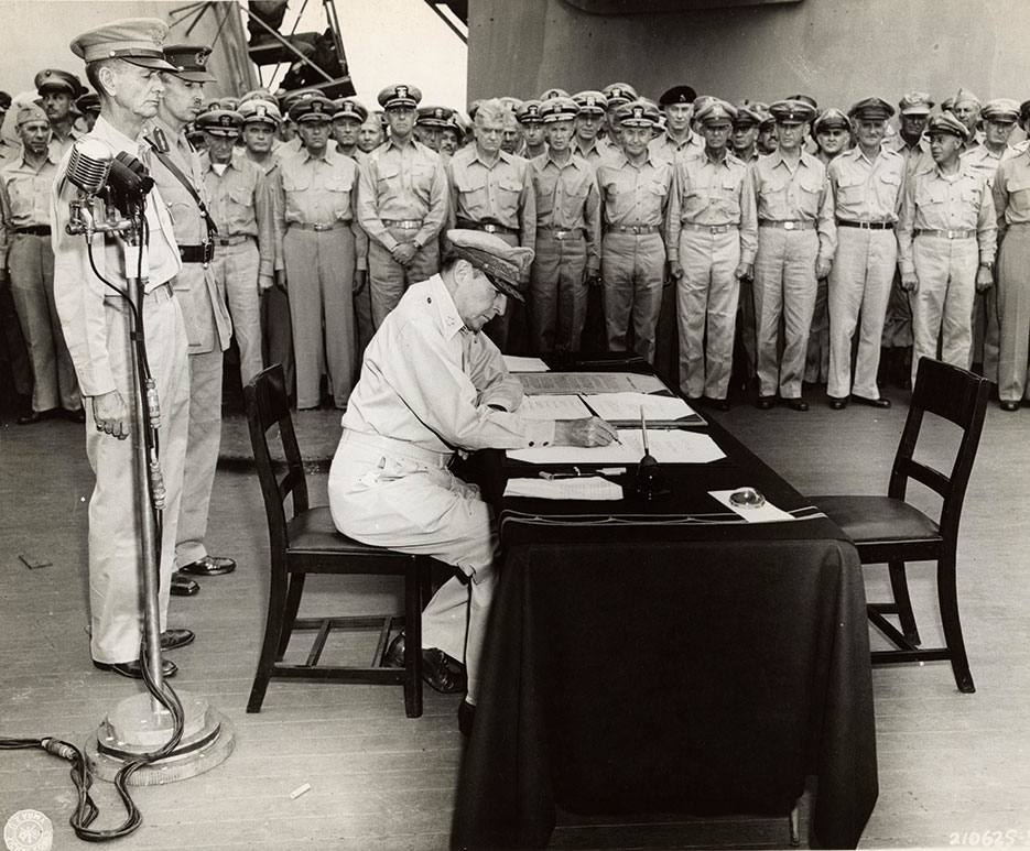 Supreme Allied Commander General Douglas MacArthur signs Instrument of Surrender on board USS Missouri, Tokyo Bay, September 2, 1945 <br />(U.S. Army Signal Corps)