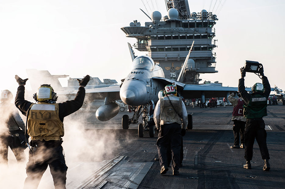 Sailors direct F/A-18C Hornet assigned to “Rampagers” of Strike Fighter Squadron 83, on flight deck of aircraft carrier USS Harry S. Truman, deployed in support of Operation Inherent Resolve, Arabian Gulf, February 2, 2016 (U.S. Navy/Lindsay A. Preston)