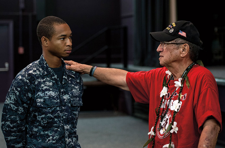 Retired Soldier and member of Statewide Prevent Suicide Hawaii Taskforce speaks to Seaman after suicide prevention seminar on Joint Base Pearl Harbor–Hickam, September 24, 2013 (U.S. Navy/Diana Quinlan)