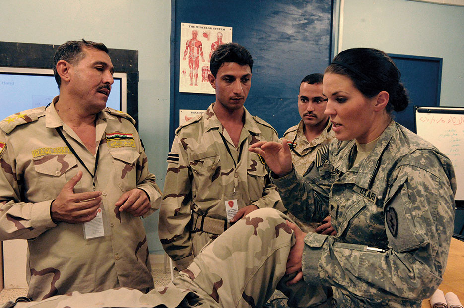 Combat medic (right) with Charlie Company, 225th Brigade Support Battalion, 2nd Advise and Assist Brigade, 25th Infantry Division, teaches Iraqi soldiers how to splint broken leg at Forward Operating Base Warhorse, Diyala Province, Iraq, October 5, 2010 (DOD/Brandon D. Bolick)