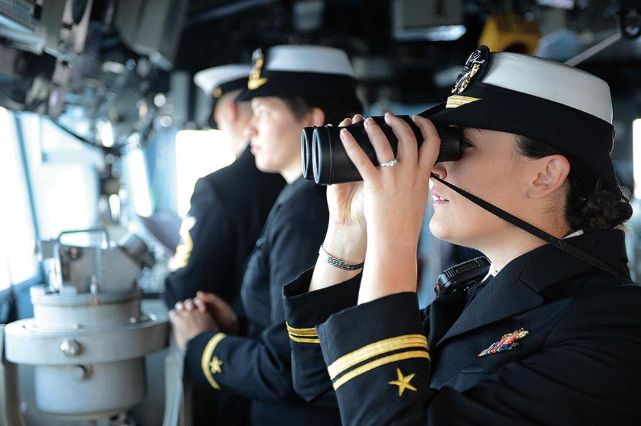 Lieutenant j.g. Stephanie Conte, USN, right, assigned to guided-missile cruiser USS <i>Antietam</i> (CG 54), stands watch as officer of the deck in bridge as ship arrives in Busan, South Korea, October 2013 (DOD/Declan Barnes)