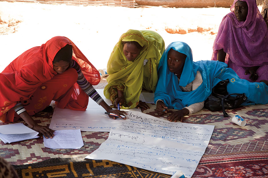 Women in Darfur’s Zam Zam camp for internally displaced persons work on recommendations during forum organized to raise awareness of issues related to gender-based violence, December 2012 (United Nations/Sojoud Elgarrai)