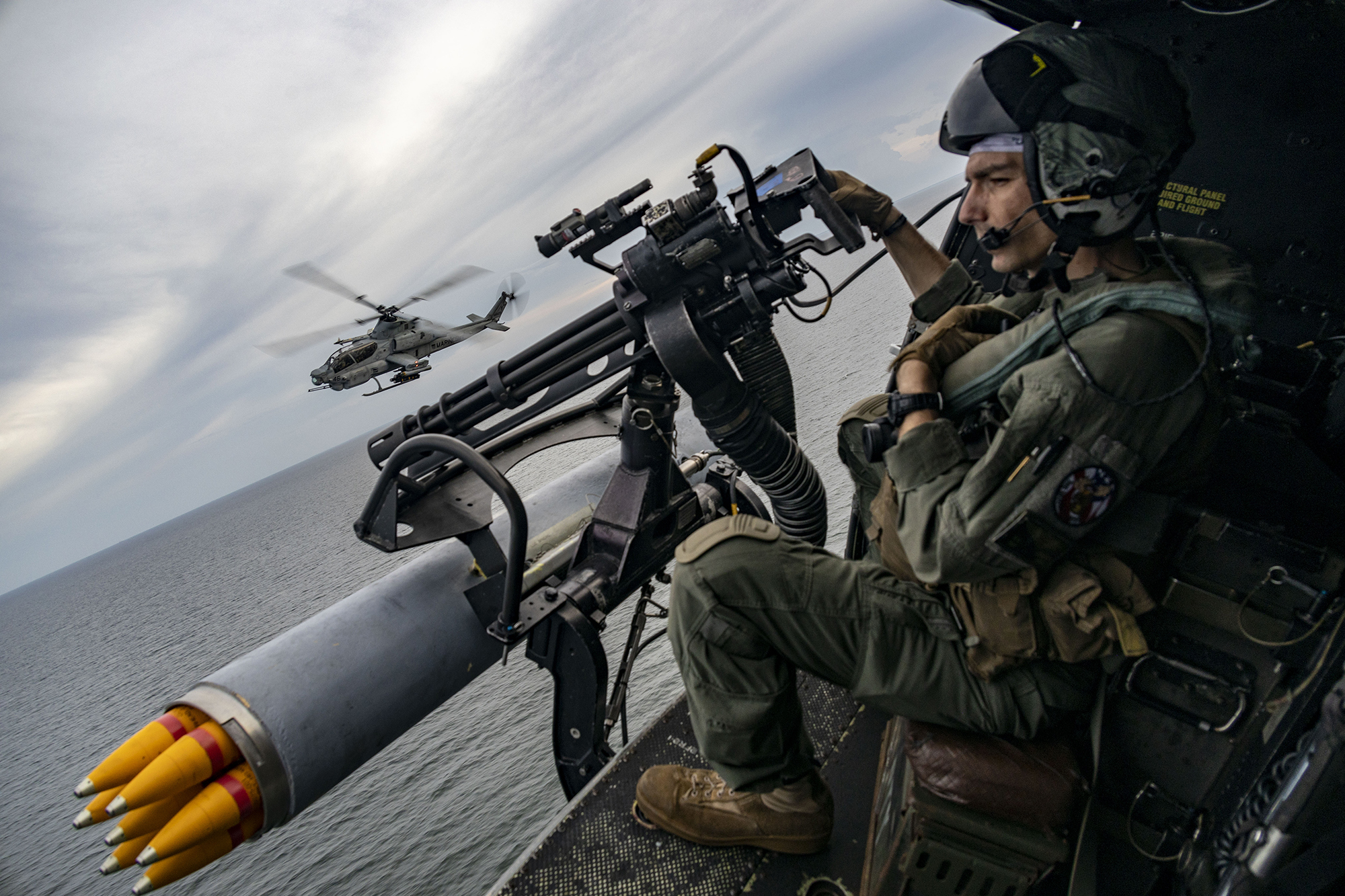 Marine Corps Sergeant Raylin Carter, aerial observer with Marine Medium Tiltrotor Squadron 362 (Reinforced), 13th Marine Expeditionary Unit, participates in flight operations with AH-1Z Viper pilots during transit of Malacca Strait, January 9, 2023 (U.S. Marine Corps/Austin Gillam) 
