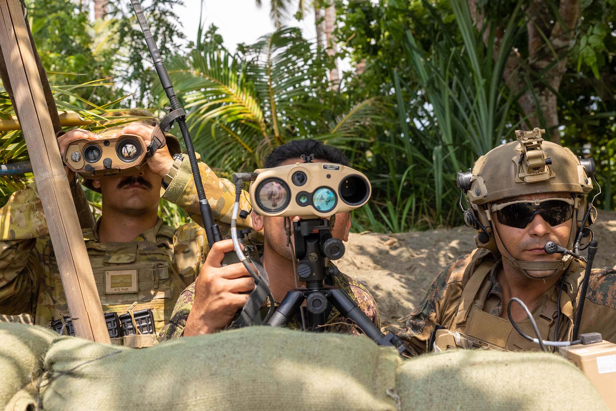 From left, Lieutenant Benjamin Buchanon, Royal Australian Artillery Fire Support Officer, Philippine Airman Sergeant Edmond V. Quimson, Jr., with 710th Special Operations Wing, and U.S. Marine Corps Sergeant Ceasar Luna, joint terminal attack controller with 1st Air Naval Gunfire Liaison Company, Marine Rotational Force–Darwin 25.3, observe target during close-air support rehearsal during exercise Balikatan 25, Philippines, April 26, 2025 (U.S. Marine Corps/Ezekieljay Correa) 