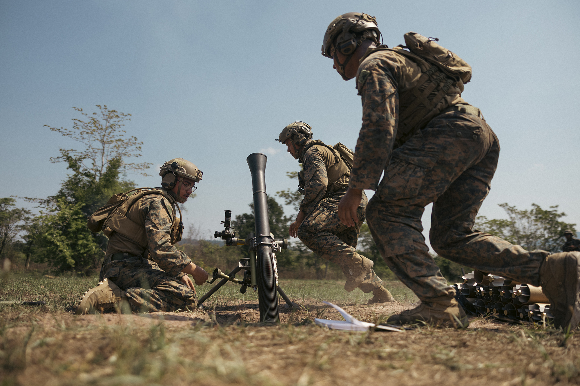 From left, Marine Corps Lance Corporal Gregory Barber, assistant gunner, Lance Corporal Rogelio MontanoSoto, assistant gunner, and Lance Corporal Ralph Garcia, squad leader, all with 1st Light Armored Reconnaissance Battalion, attached to Marine Rotational Force-Southeast Asia, fire M252 81mm mortar system during Marine final exercise at Ban Chan Khrem, Chanthaburi, Thailand, March 6, 2025, during exercise Cobra Gold 2025 (U.S. Marine Corps/Shaina Jupiter)