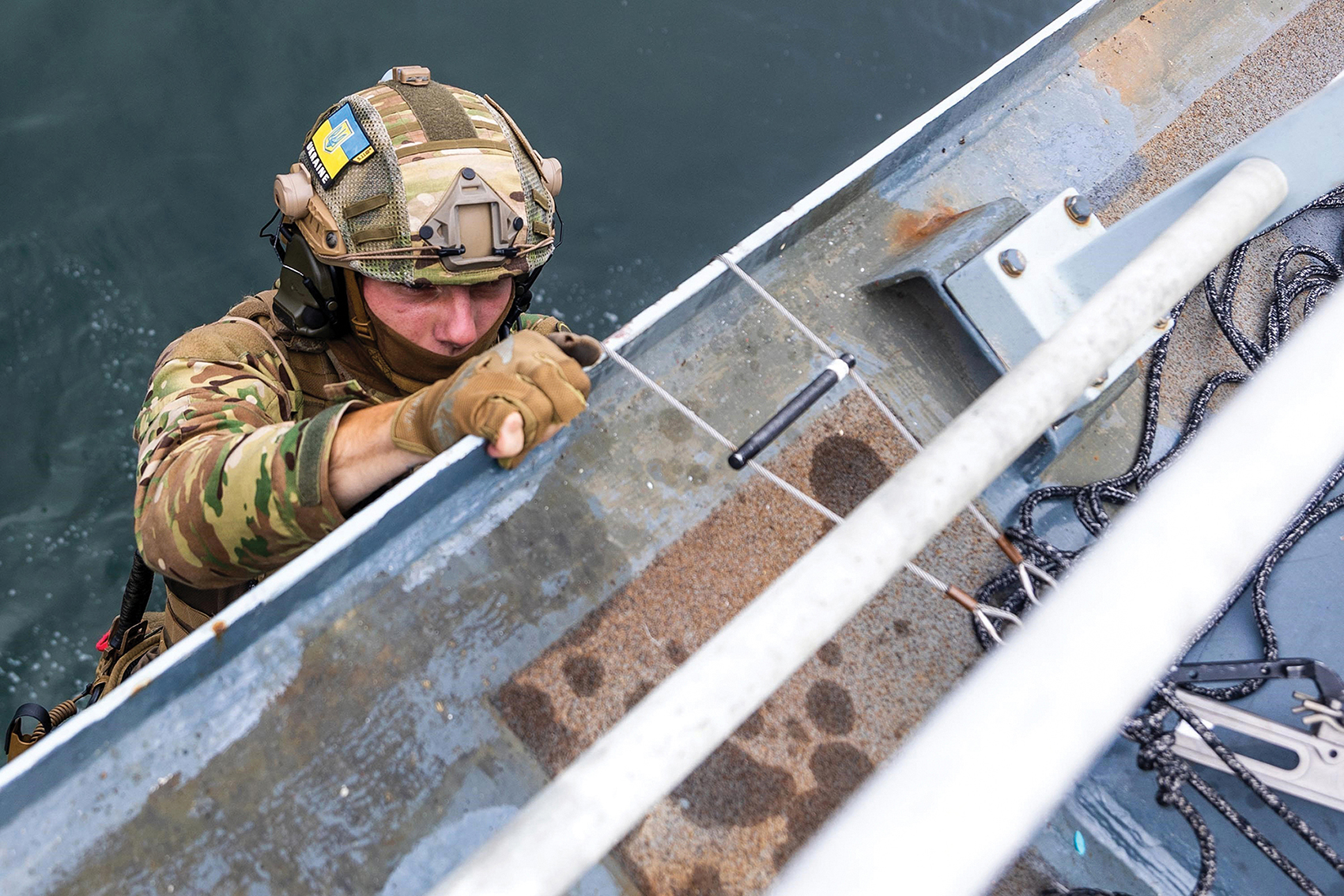 Ukrainian special forces soldier climbs to deck of ship during visit, board, search, and seizure training with British Royal Marine Commandos and  U.S. Navy SEALs in Odesa, Ukraine, June 21, 2021 (U.S. Army/Patrik Orcutt)