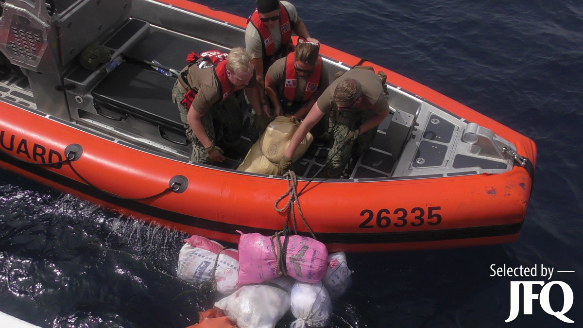 Coastguardsmen from USCGC Glen Harris recover bags of illegal narcotics discarded by fishing vessel interdicted in Gulf of Oman