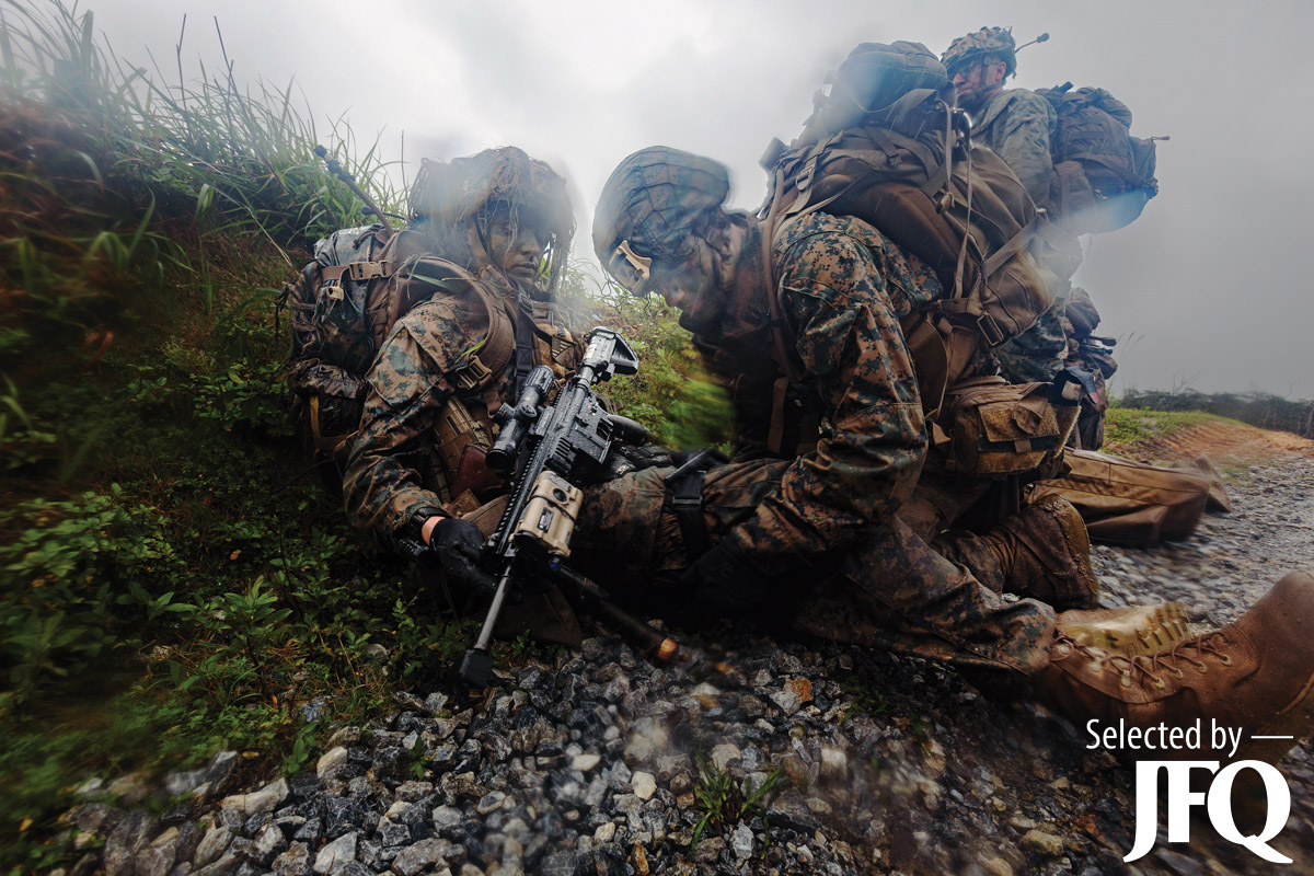 Navy corpsman applies tourniquet on simulated casualty during counter assault exercise in Okinawa, Japan
