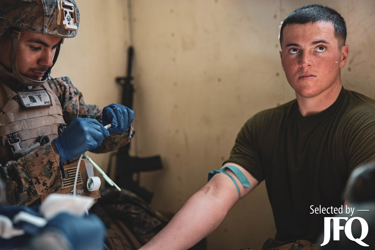 Navy corpsmen activate Valkyrie blood transfusion under supervision of evaluators during expeditionary medical integration course