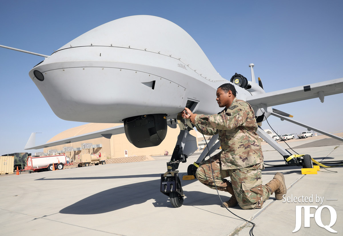 Army Private First Class conducts maintenance on MQ-1C Gray Eagle in preparation for Project Convergence 21