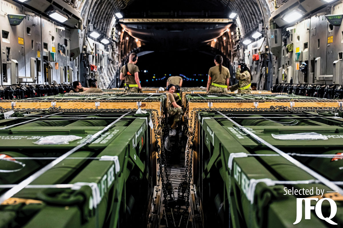 Airmen assigned to 305th Aerial Port Squadron upload Guided Multiple Launch Rocket System munitions onboard Boeing 767