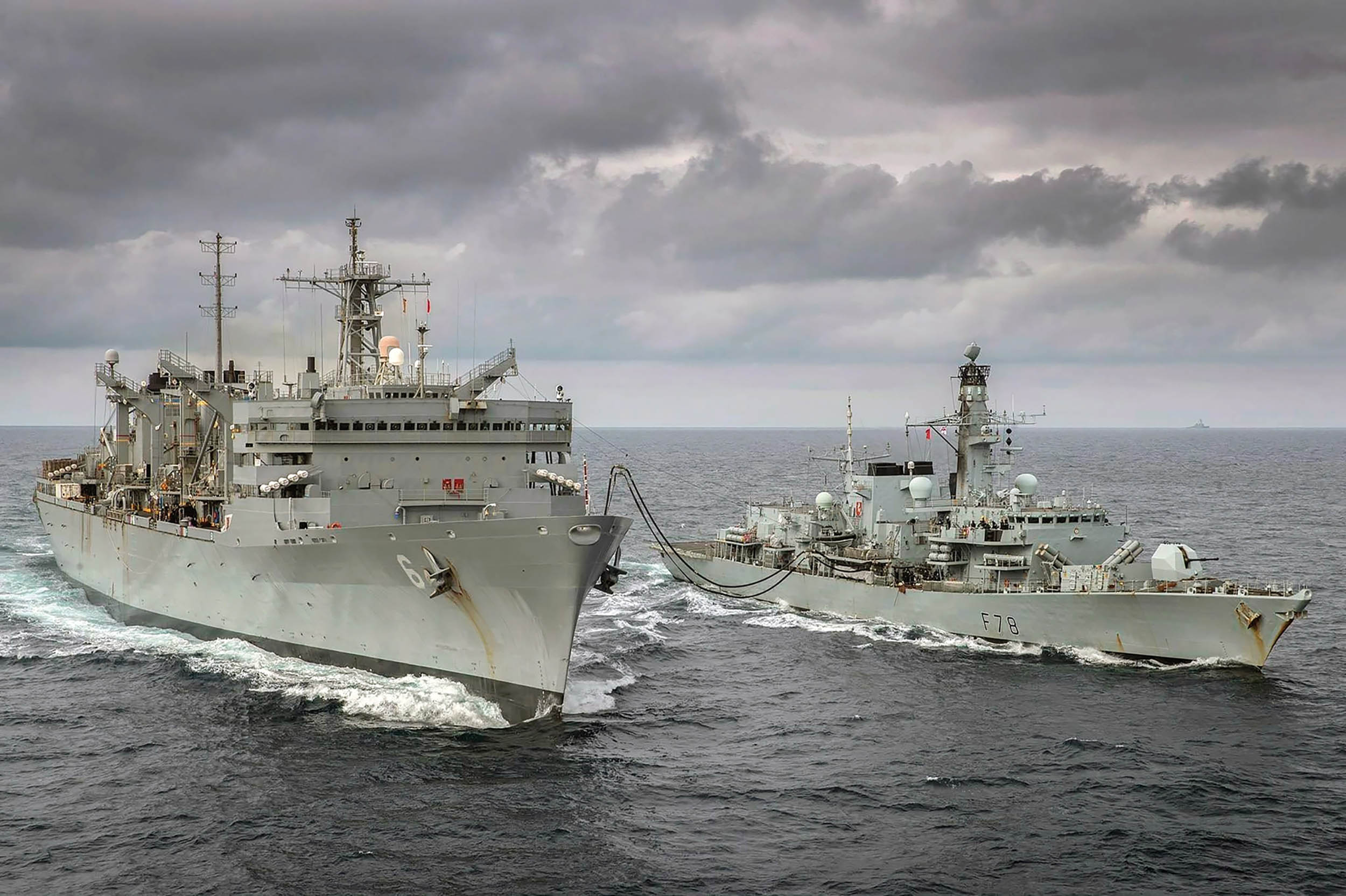 Fast combat support ship and the Royal Navy frigate conduct replenishment-at-sea