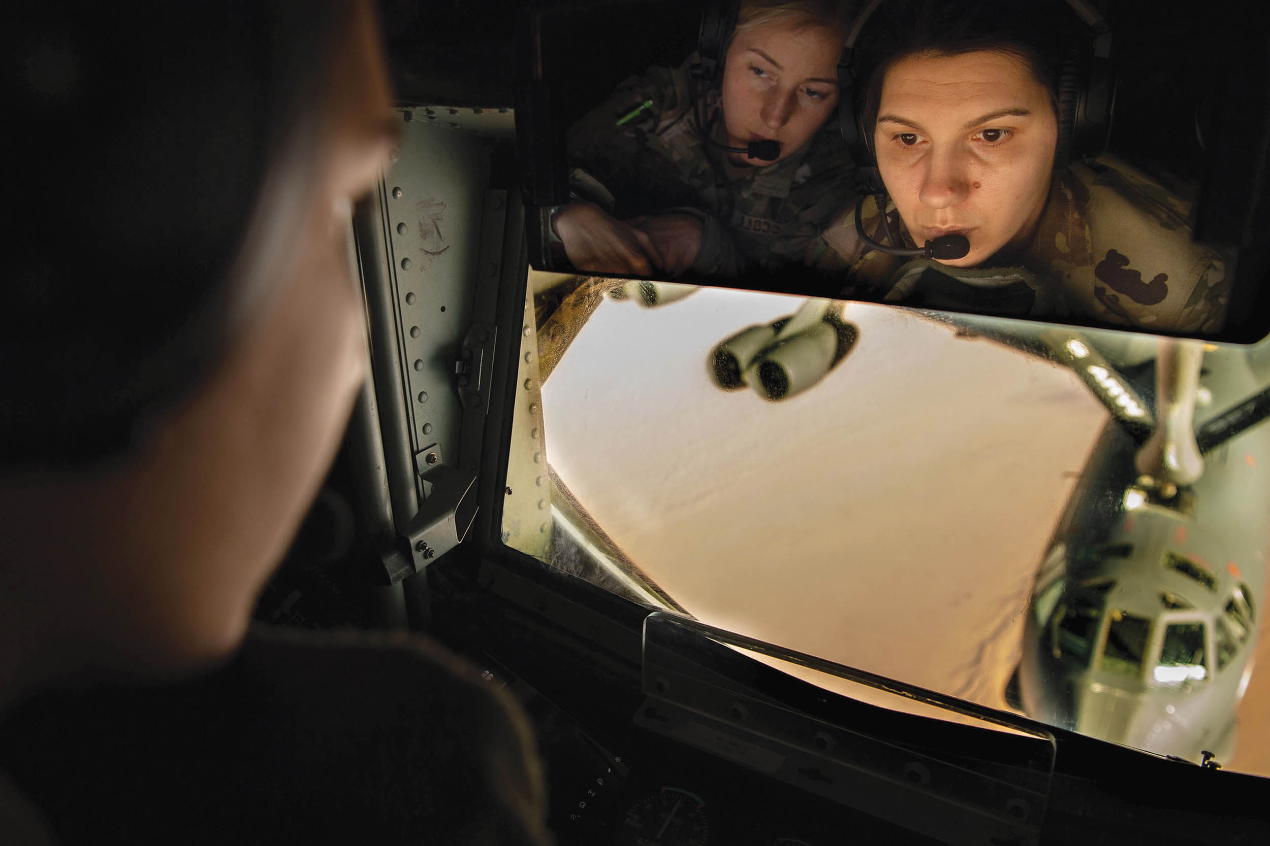 Air Force in-flight refueling operator and pilot observe refueling of B-52 Stratofortress