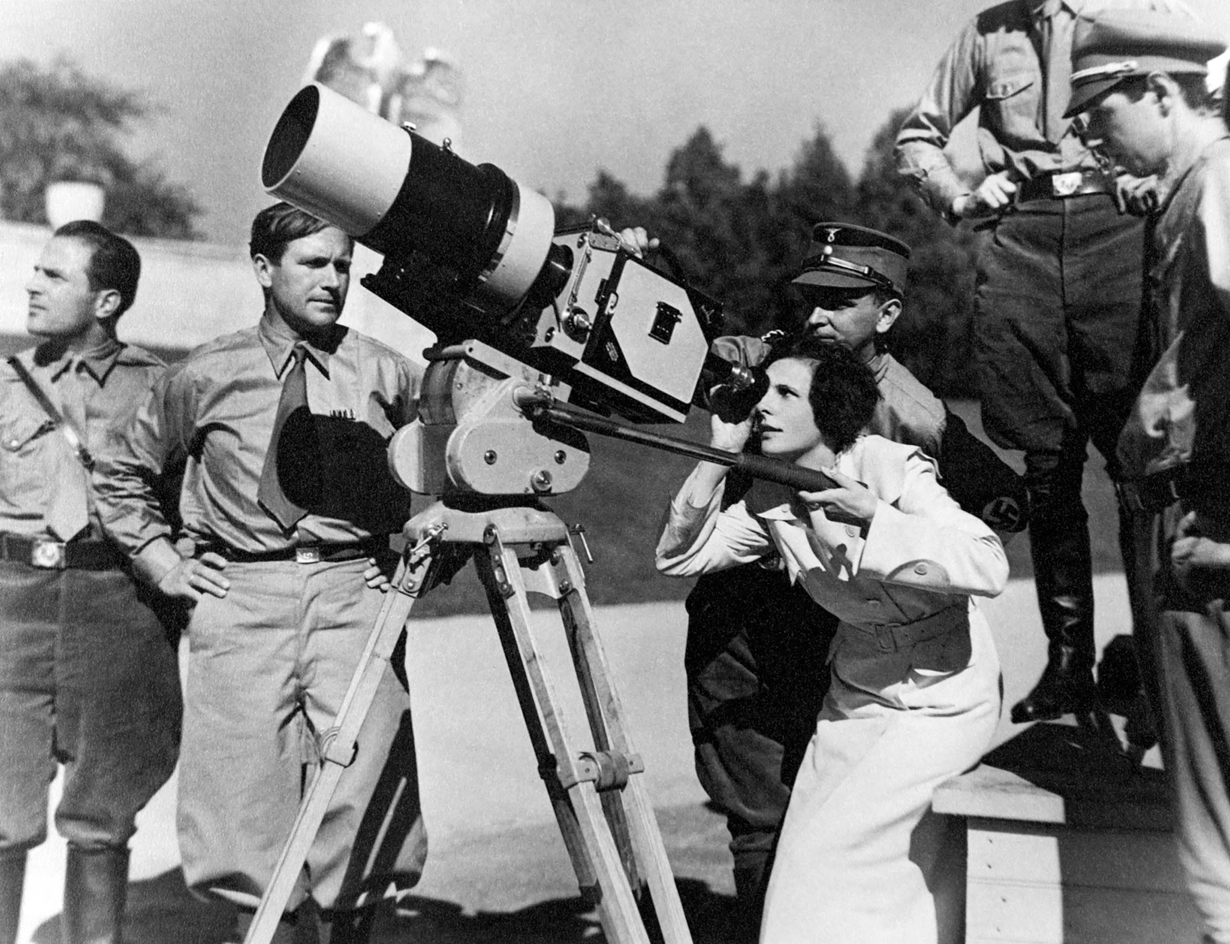 German film director Leni Riefenstahl looks through large camera with cinematographer Sepp Allgeier during Nazi Party Congress in Nuremberg