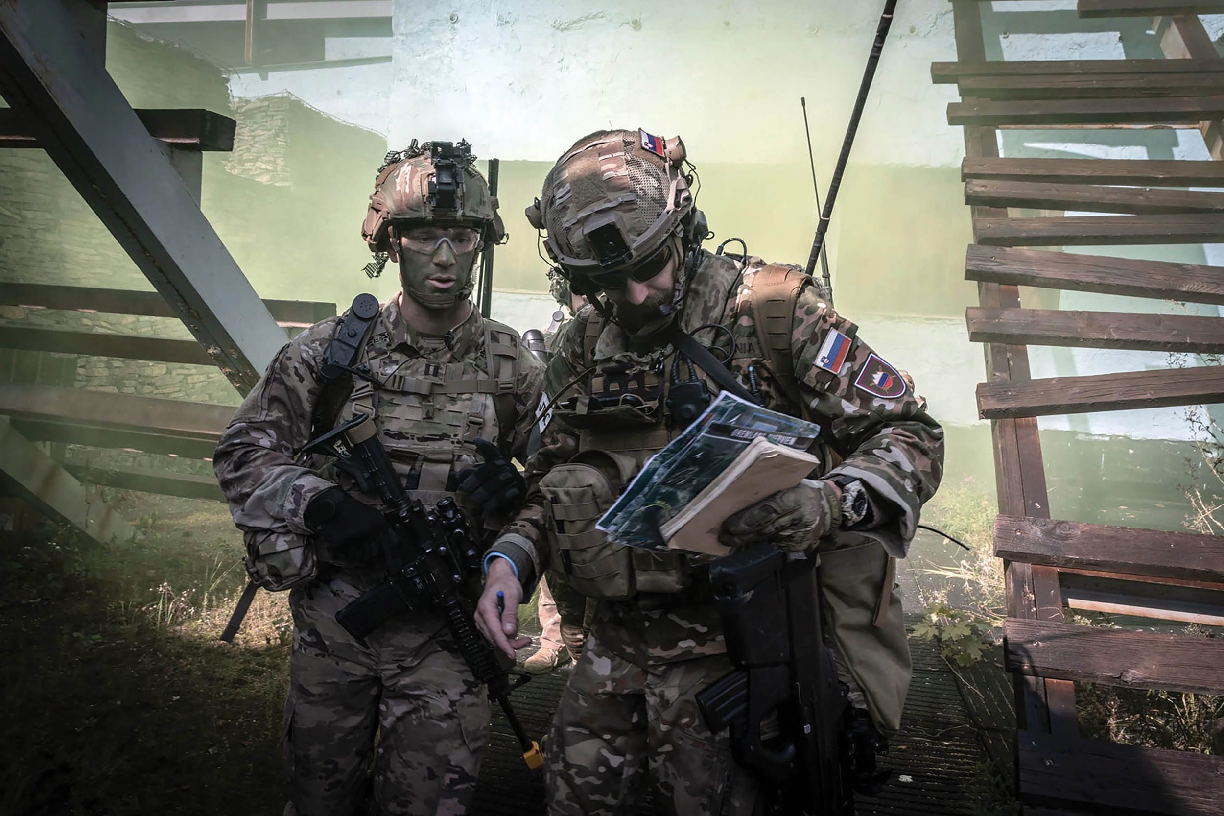 U.S. Servicemember and Slovak soldier discuss tactics during NATO exercise Strong Cohesion 2022