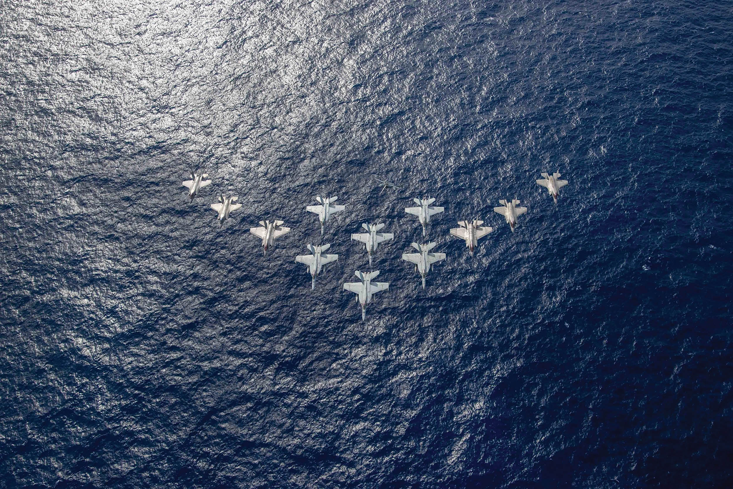 Aircraft from United Kingdom’s carrier strike group led by HMS Queen Elizabeth, and U.S. Navy carrier strike groups led by flagships USS Ronald Reagan and USS Carl Vinson, fly in formation during carrier strike group operations in Philippine Sea