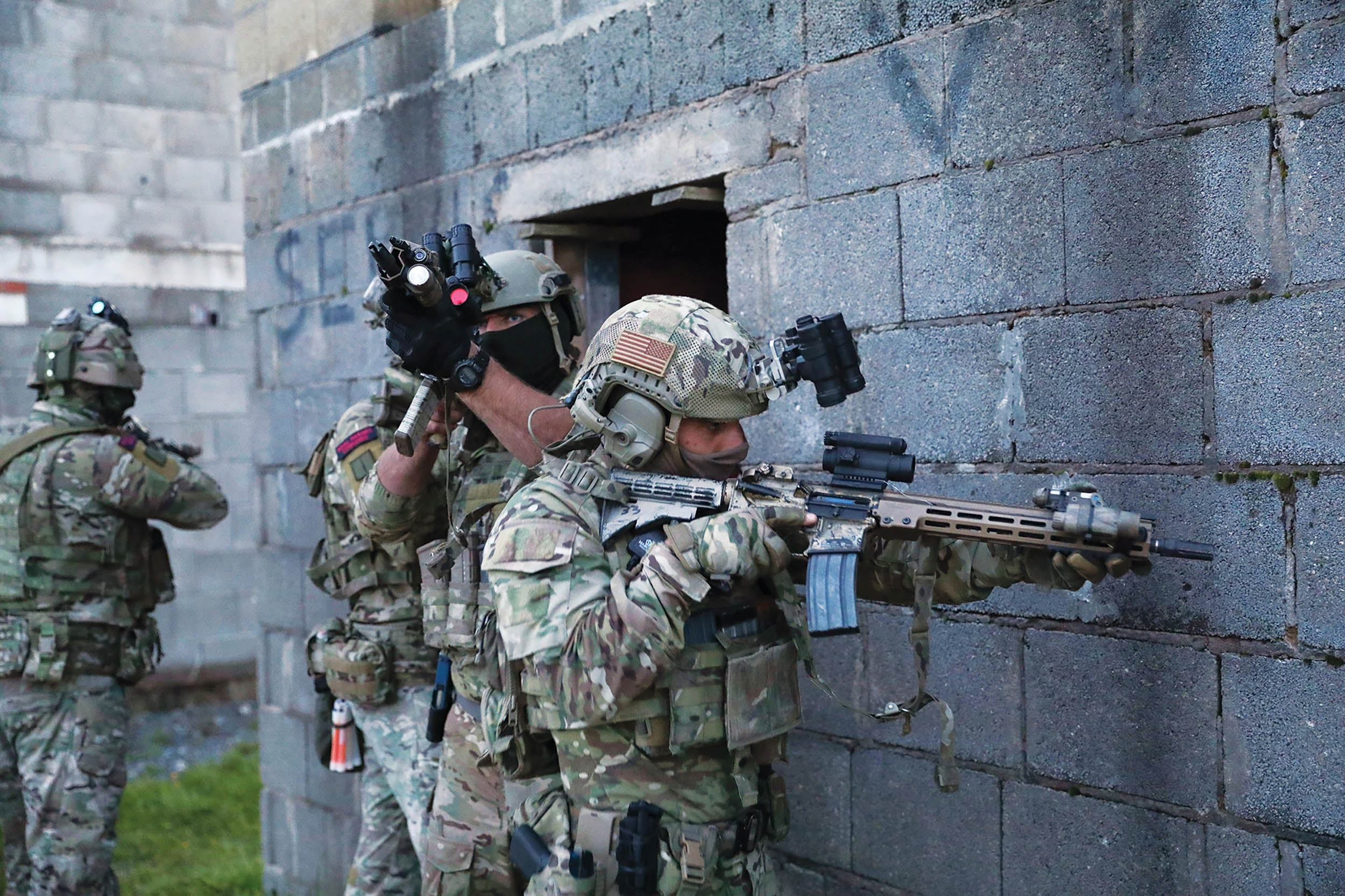 United Kingdom Royal Marines and U.S. Army Green Berets provide security before entering building during close quarter battle training at Grafenwöhr Training Area
