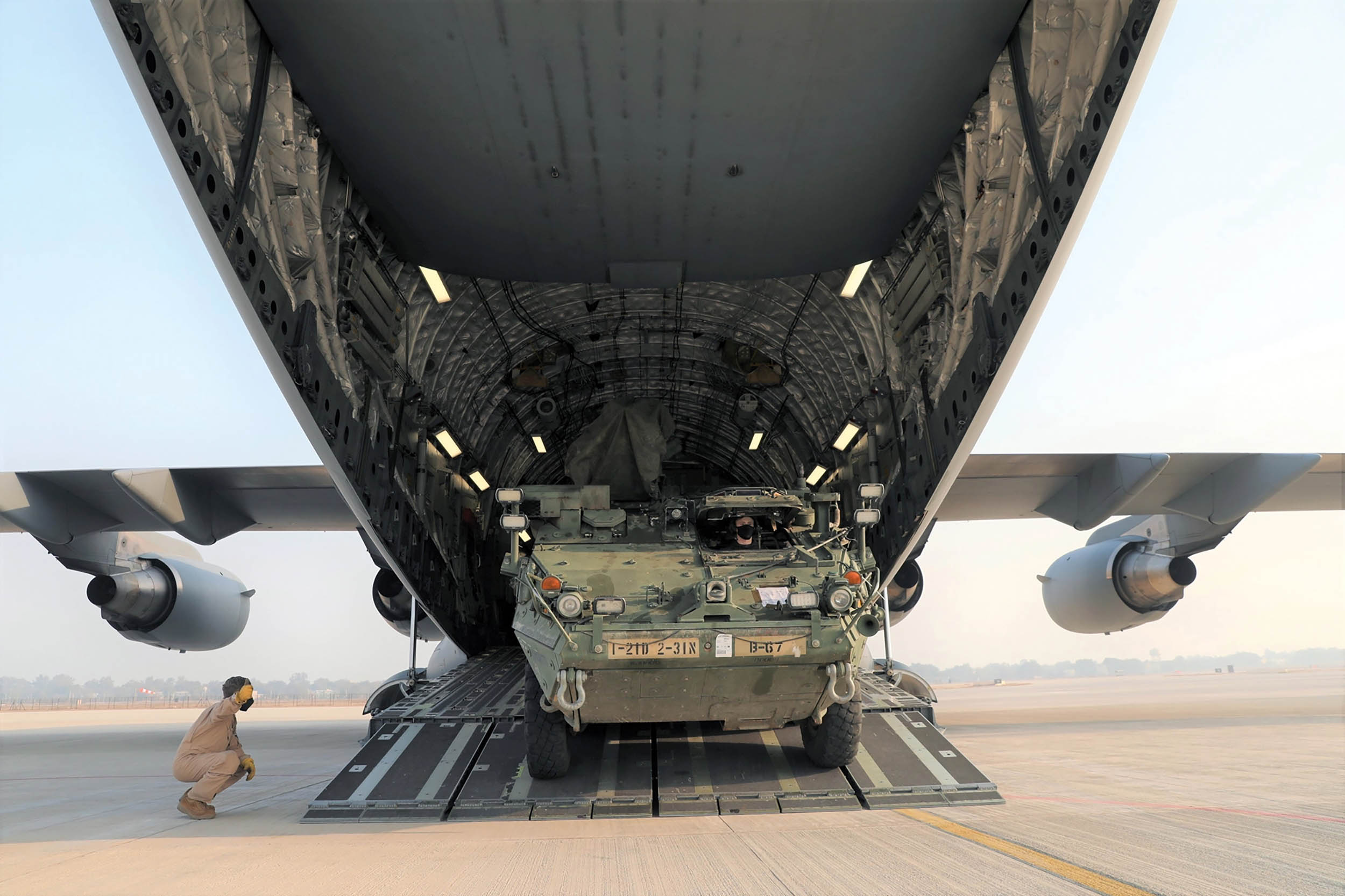 Army Stryker infantry carrier vehicle rolls off C-17 cargo plane in India