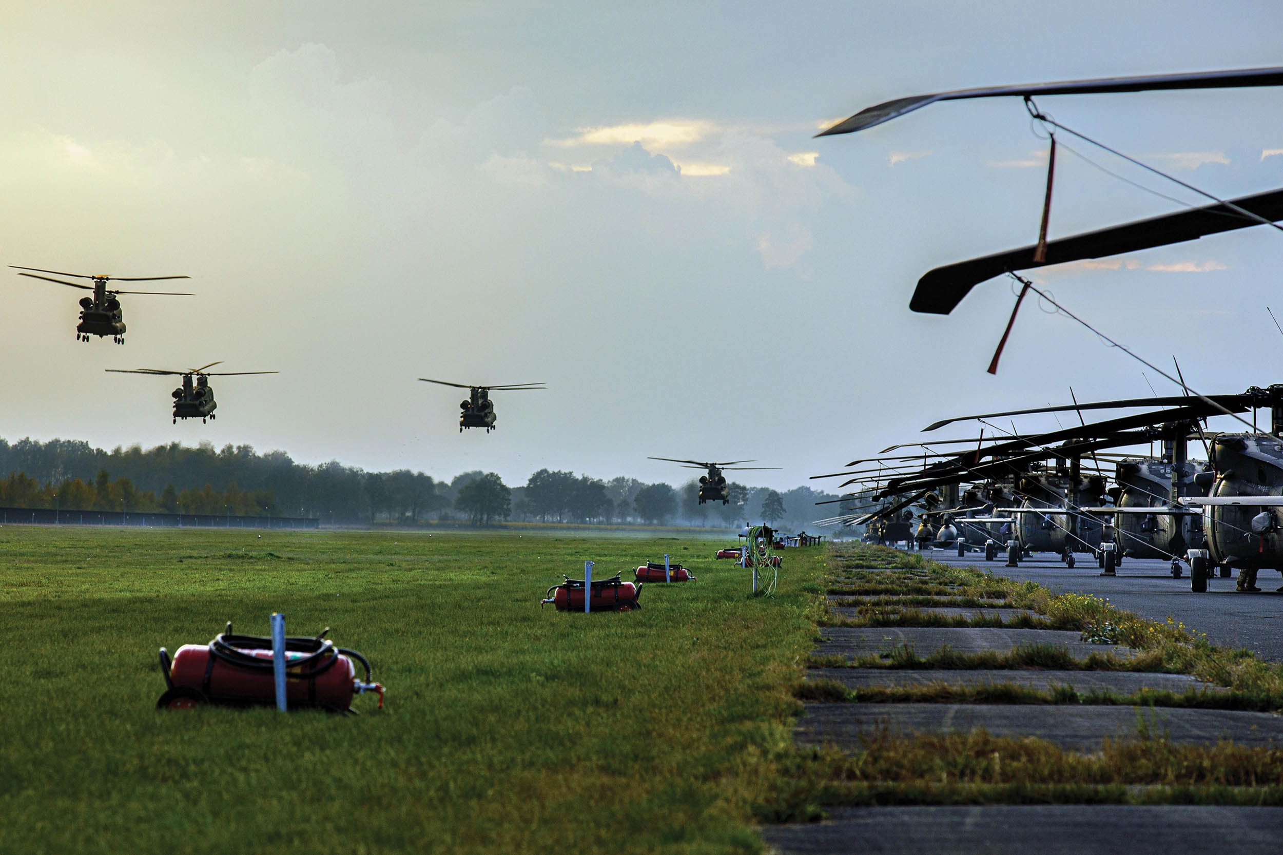 Four Army CH-47F Chinook helicopters from 1st Battalion, 214th Aviation Regiment (General Support Aviation Battalion), 12th Combat Aviation Brigade, prepare to land during exercise Falcon Autumn 22 at Vredepeel, Netherlands, November 4, 2022 (U.S. Army/Thomas Mort)
