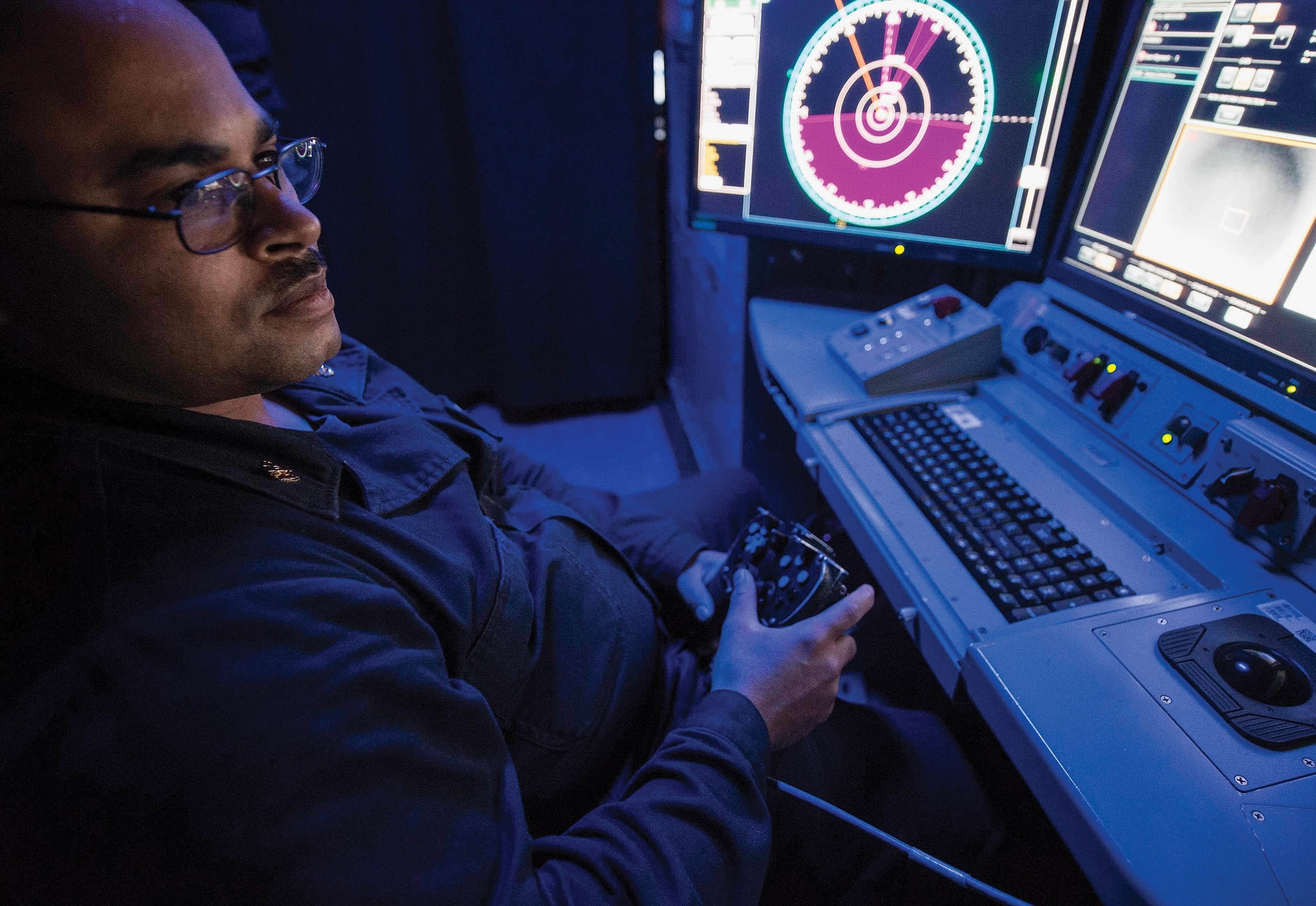 Chief Electronics Technician Travis Hill operates console of Laser Weapon System aboard Afloat Forward Staging Base (Interim) USS Ponce to track Scan Eagle unmanned aerial vehicle, Arabian Gulf, July 13, 2017 (U.S. Navy/Joshua Bryce Bruns)
