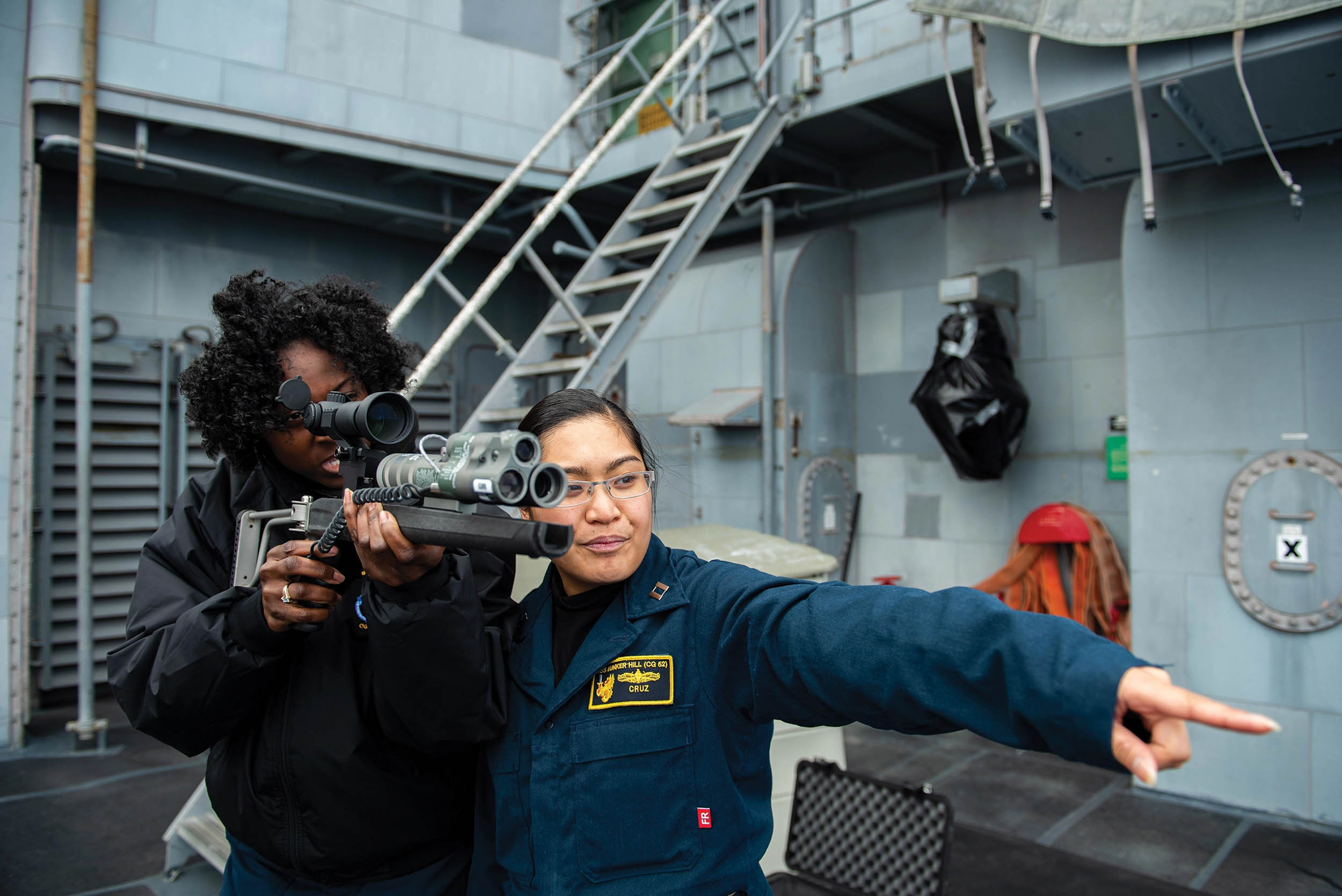 Lieutenant Joanna Cruz, right, gives laser dazzler gun training to Quartermaster 1st Class Kahzia Johnson-Baker, aboard USS Bunker Hill, Pacific Ocean, January 24, 2020 (U.S. Navy/Nicholas V. Huynh)