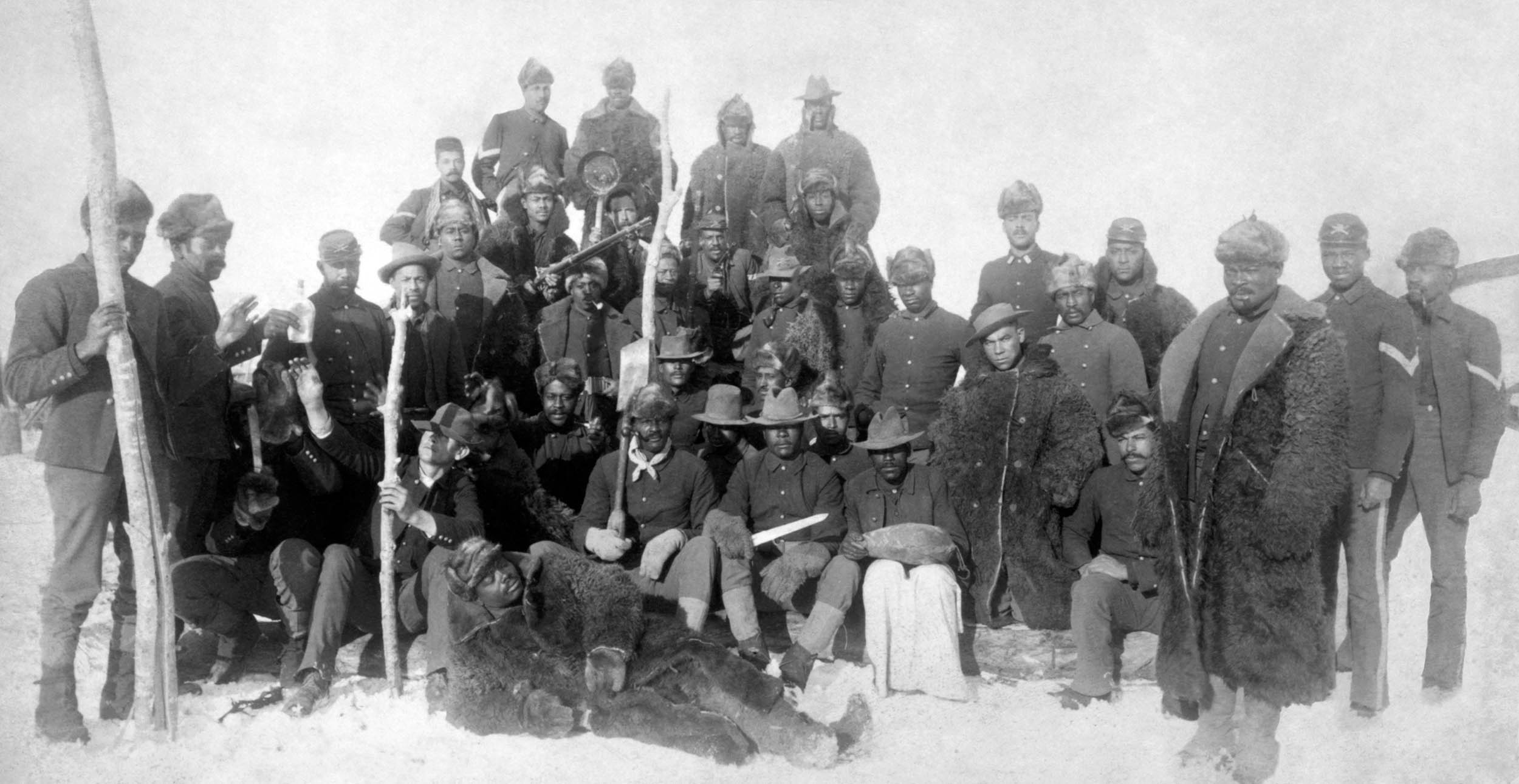 Buffalo Soldiers of 25th Infantry, some wearing buffalo robes, Fort Keogh, Montana, 1890 (Library of Congress)