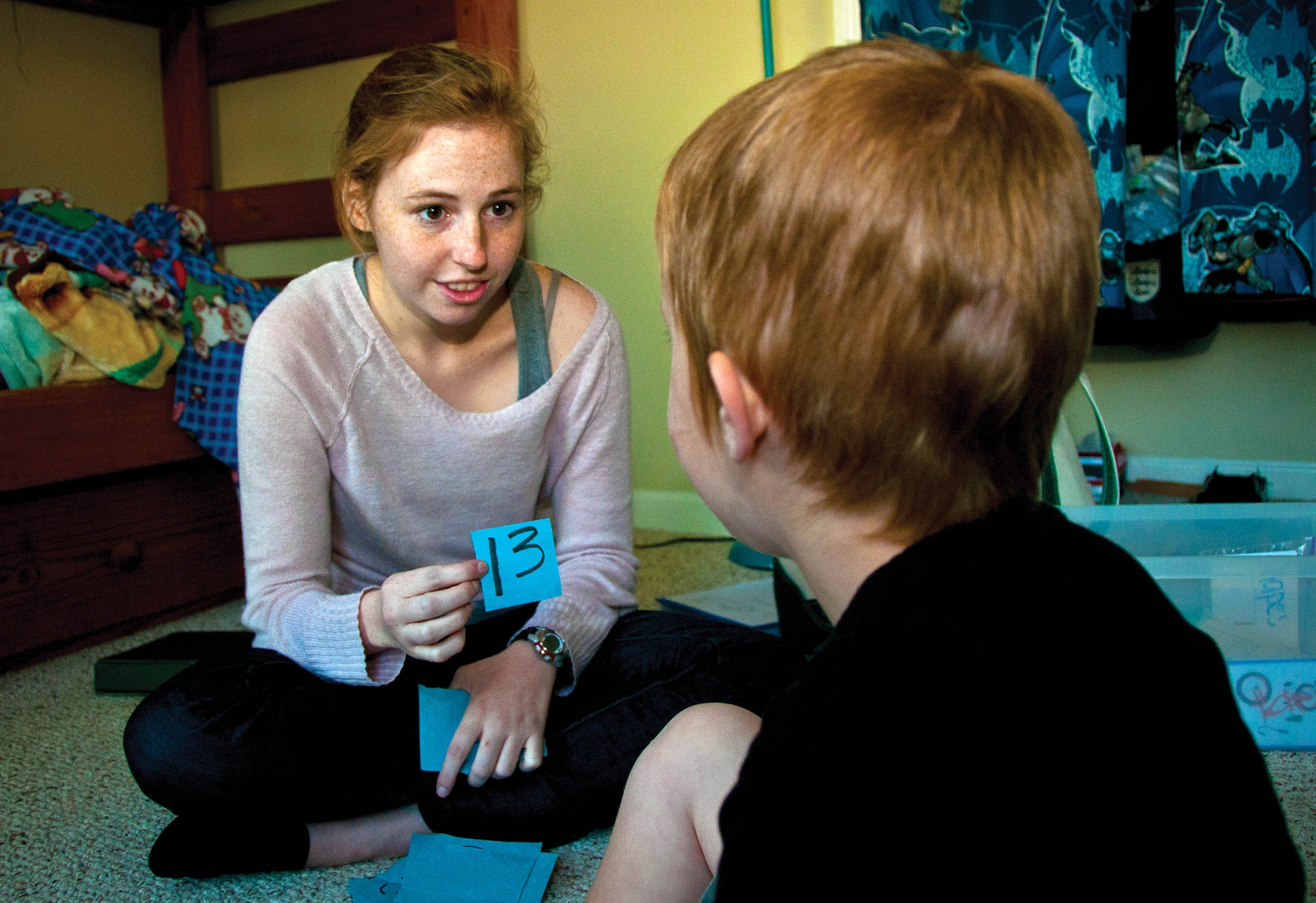 Kayleigh Norton, applied behavior analysis therapist, reviews numbers with Carl, son of Sarah and Technical Sergeant Carl Sole, 628th Security Forces Squadron flight chief, April 13, 2012, Joint Base Charleston, South Carolina (U.S. Air Force/Dennis Sloan)