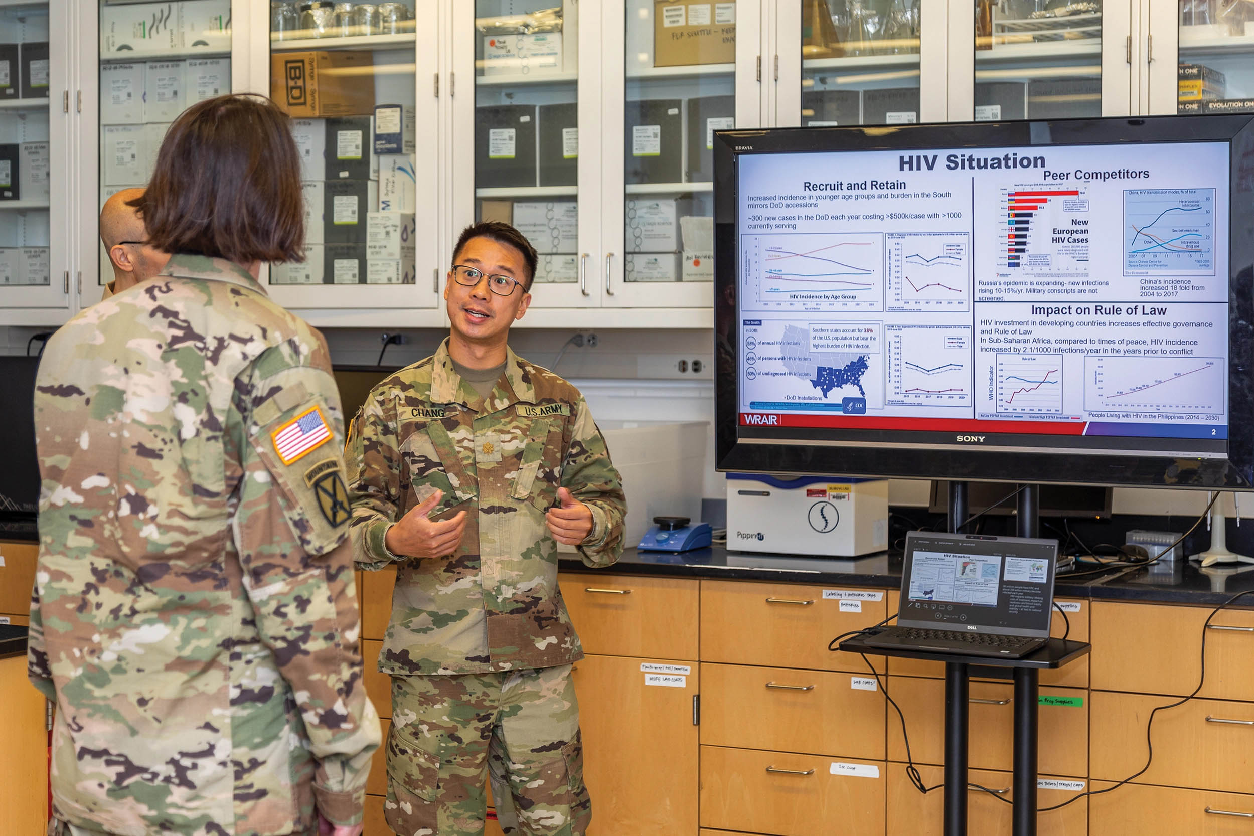 Major David Chang and Captain Sean Cavanaugh brief Brigadier General Wendy L. Harter on the HIV Research Program at Walter Reed Army Institute of Research, June 29, 2021 (U.S. Army/Arlen Caplan)