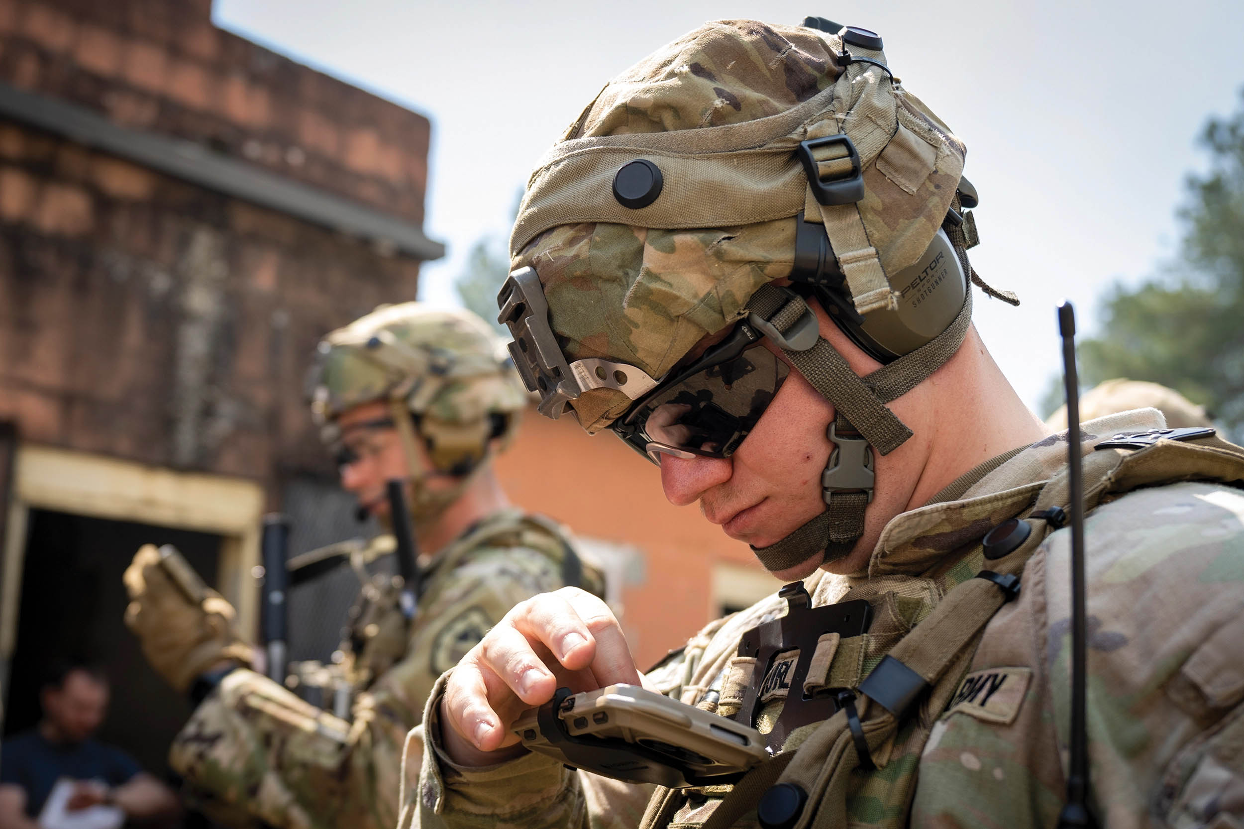 Soldiers check Nett Warrior end-user devices during Army Expeditionary Warrior Experiment force-on-force field demonstration held on Fort Moore (formerly Fort Benning), Georgia, March 4, 2021 (U.S. Army/Jason Amadi)