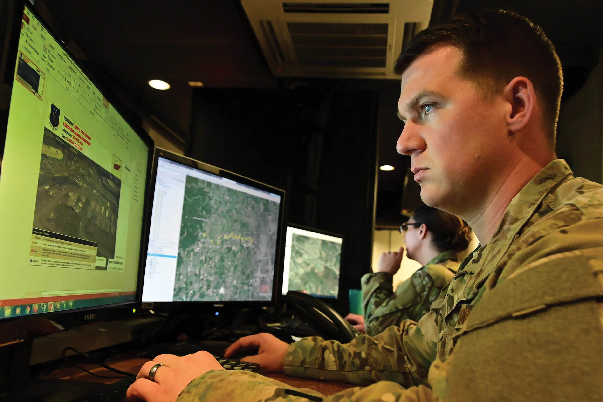Airman from 118th Intelligence, Surveillance, and Reconnaissance Group, Tennessee Air National Guard, examines images of tornado damage across Tennessee, March 4, 2020, at Berry Field Air National Guard Base, Nashville, Tennessee (U.S. Air National Guard/Anthony Agosti)