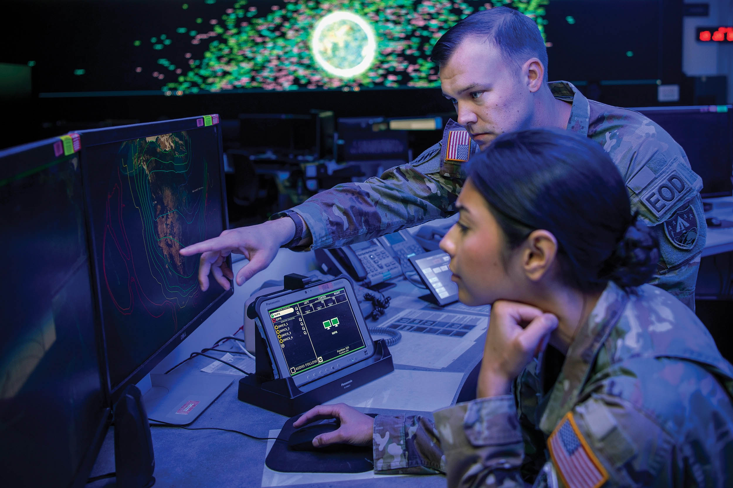 Army Major Mitchell Daugherty, mission director for National Space Defense Center, works with Space Force 1st Lieutenant Tia Scoggan, weapons and tactics section chief for 18th Space Defense Squadron Det. 1, at Schriever Space Force Base, Colorado, October 5, 2022 (U.S. Space Force/Tiana Williams)
