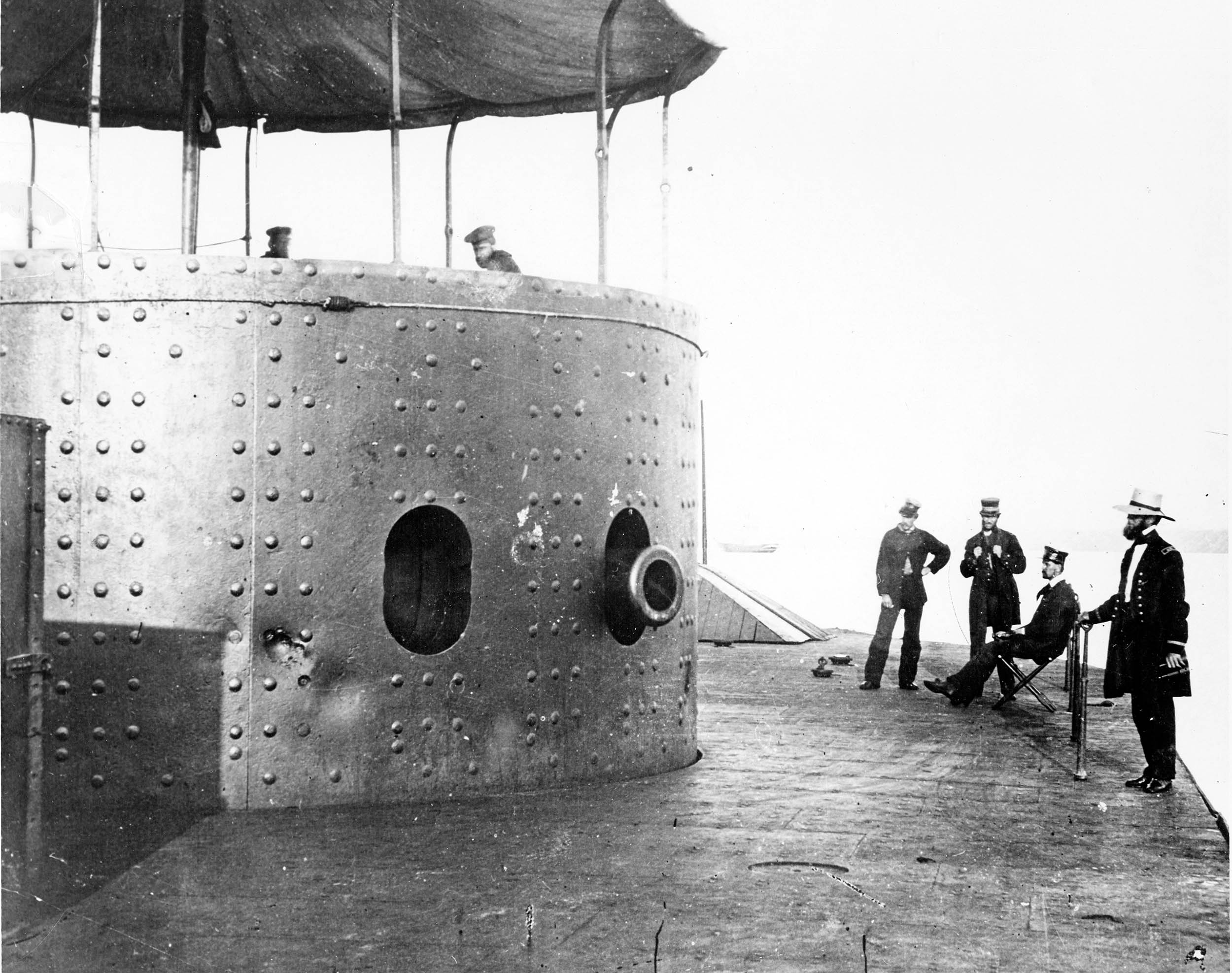 Deck of USS Monitor, on James River in Virginia, July 9, 1862; officers at right (left to right): Third Assistant Engineer Robinson W. Hands, Acting Master Louis N. Stodder, Second Assistant Engineer Albert B. Campbell (seated), and Acting Volunteer Lieutenant William Flye (with binoculars) (U.S. Navy/Naval History and Heritage Command)