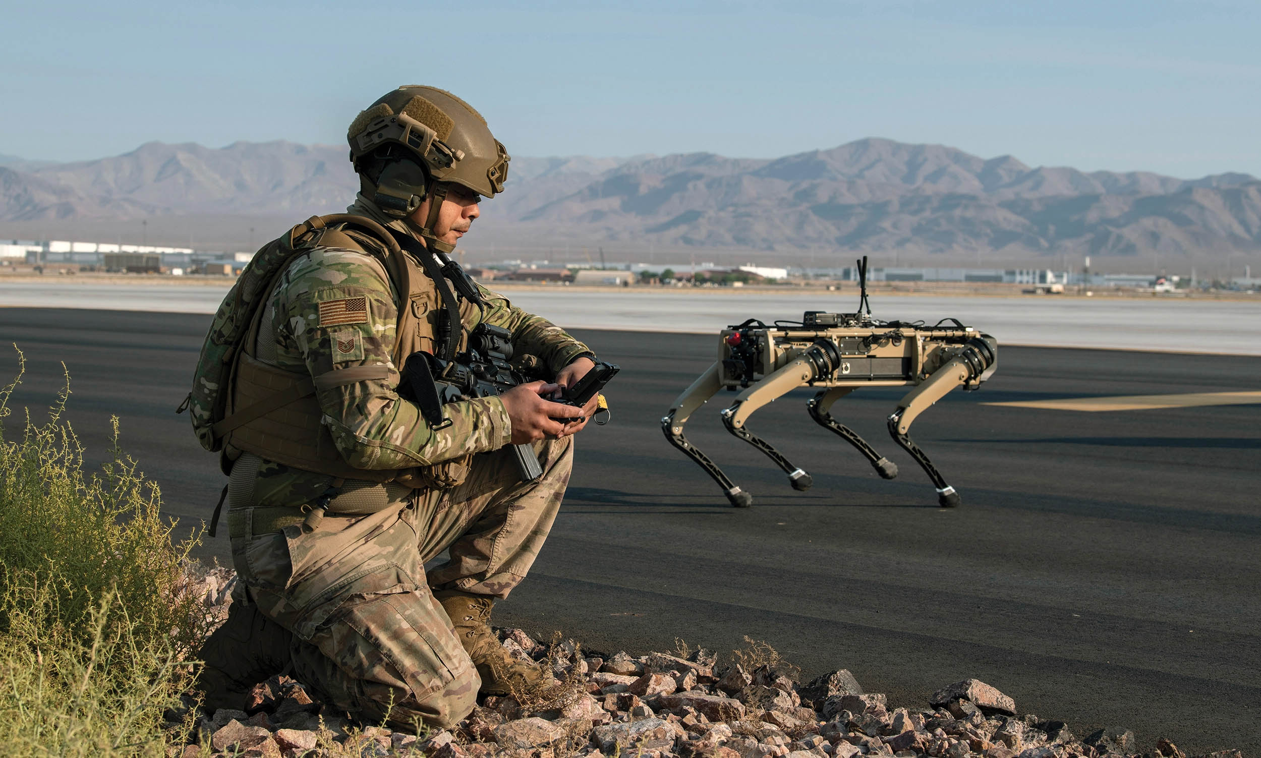 Air Force Technical Sergeant patrols with Ghost Robotics Vision 60 prototype at simulated austere base during Advanced Battle Management System exercise on Nellis Air Force Base, Nevada, September 3, 2020 (U.S. Air Force/Cory D. Payne)