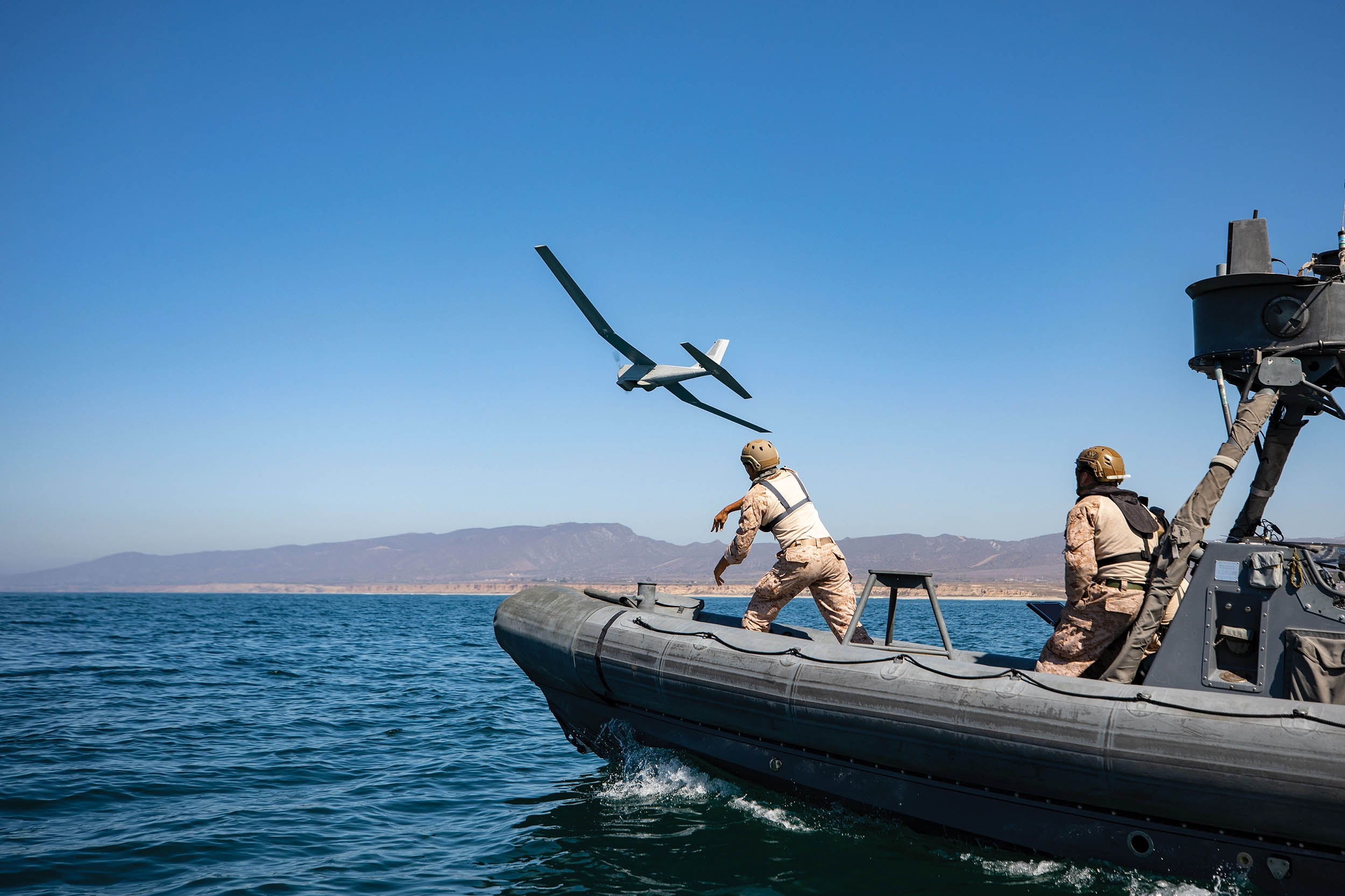 Corporal Thomas Rexrode, reconnaissance Marine with Company A, 1st Reconnaissance Battalion, 1st Marine Division, launches RQ-20B Puma small unmanned aircraft system from rigid-hull inflatable boat at Camp Pendleton, California, September 30, 2021 (U.S. Marine Corps/Connor Hancock)