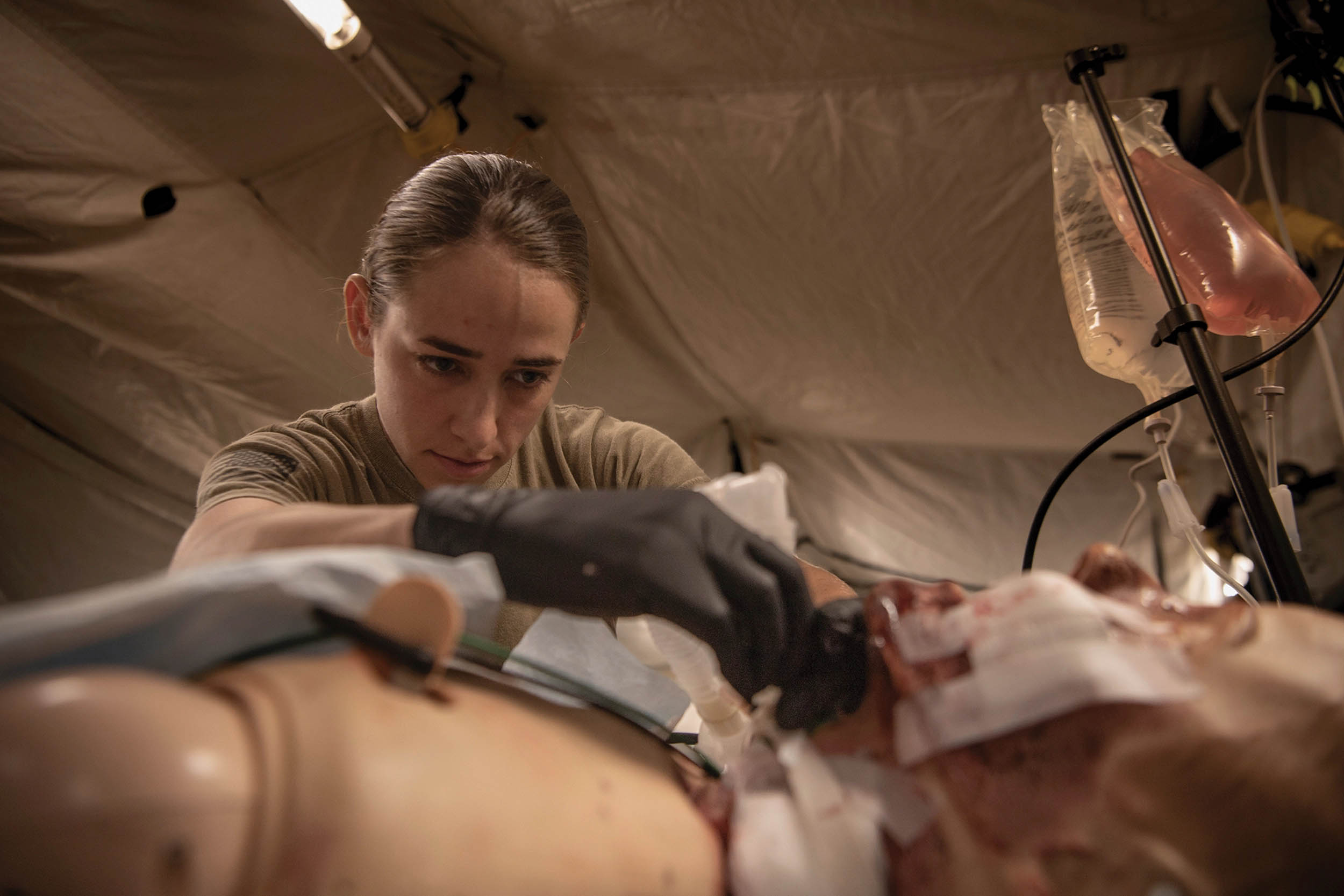 Army Captain Ashley Sarlo, critical care nurse attached to 240th Forward Resuscitative Surgical Detachment, simulates experimental postoperative critical care at Camp Grayling, Michigan, August 12, 2023, during Northern Strike 2023 (U.S. Air National Guard/Jacob Cessna)