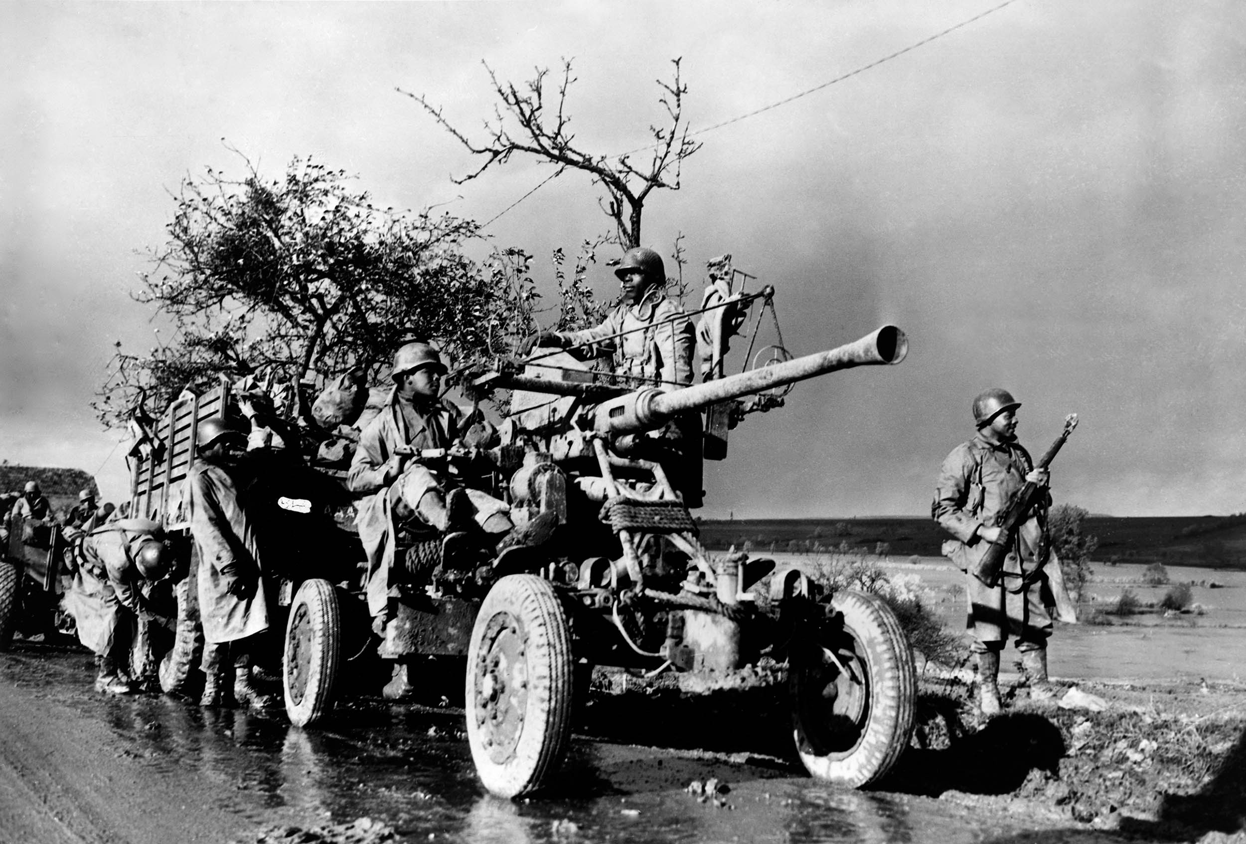 Soldiers with the 452nd Antiaircraft Artillery Battalion stand by and check their equipment during convoy in Belgium, November 4, 1944 (U.S. Army Signal Corps/Library of Congress)