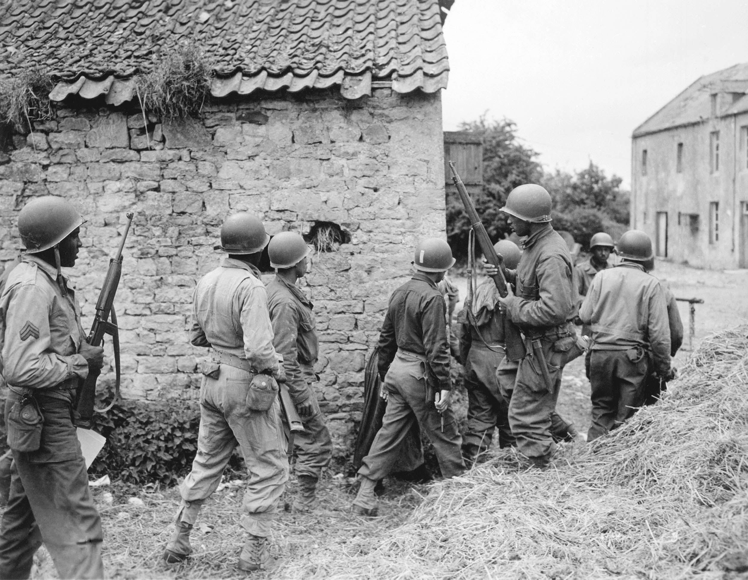 Soldiers surround farmhouse as they prepare to eliminate German sniper, near Vierville-sur-Mer, France, June 10, 1944 (U.S. Army/National Archives and Records Administration)