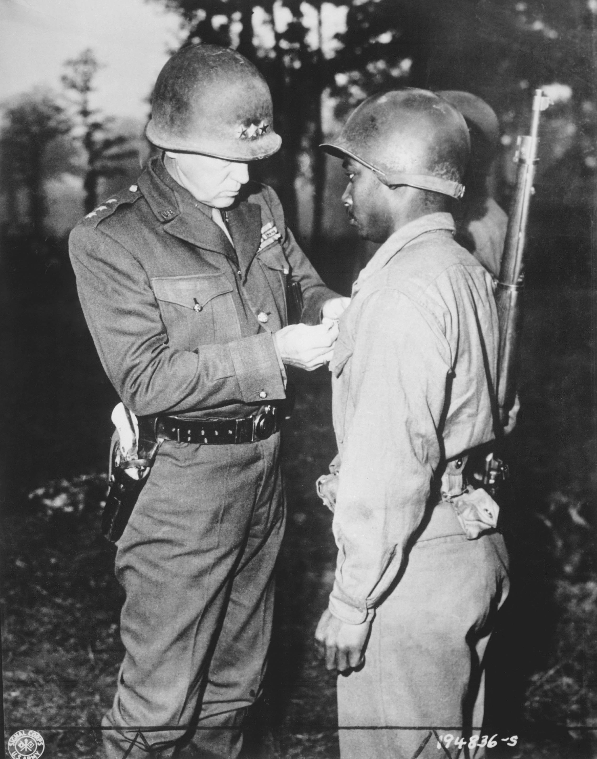 Lieutenant General George S. Patton, U.S. Third Army commander, pins Silver Star on Private Ernest A. Jenkins, of New York City, for his conspicuous gallantry in liberation of Châteaudun, France, October 13, 1944 (U.S. Army Signal Corps/National Archives and Records Administration)